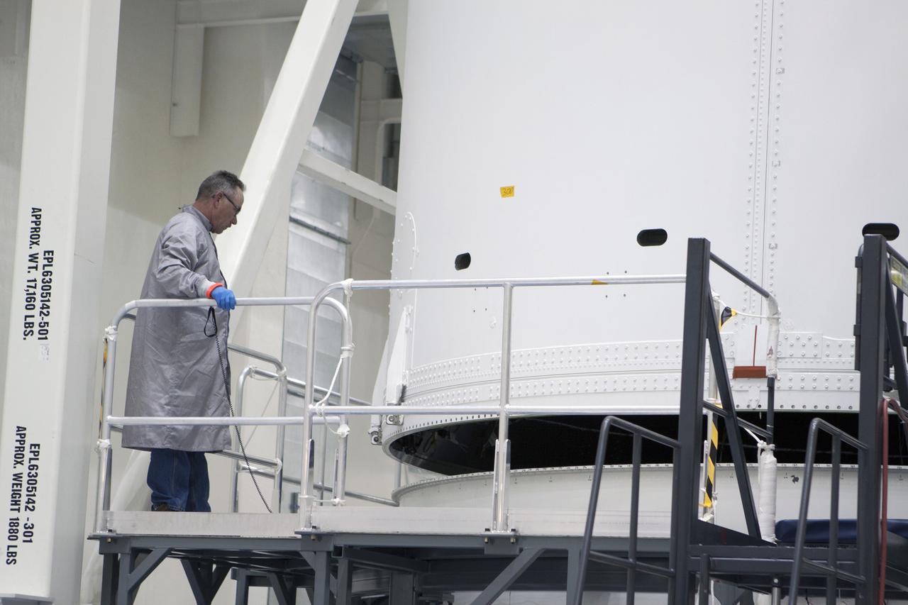 CAPE CANAVERAL, Fla. -- Inside the Operations and Checkout Building high bay at NASA's Kennedy Space Center in Florida, a Lockheed Martin technician monitors the progress as a crane is used to lift the Orion service module from a test stand and move it to the Final Assembly and System Testing, or FAST, cell further down the aisle. The Orion crew module will be stacked on the service module in the FAST cell and then both modules will be put through their final system tests for Exploration Flight Test-1, or EFT-1, prior to rolling out of the facility for integration with the United Launch Alliance Delta IV Heavy rocket.    Orion is the exploration spacecraft designed to carry astronauts to destinations not yet explored by humans, including an asteroid and Mars. It will have emergency abort capability, sustain the crew during space travel and provide safe re-entry from deep space return velocities. The first unpiloted test flight of Orion, EFT-1, is scheduled to launch later this year atop a Delta IV rocket from Cape Canaveral Air Force Station in Florida to an altitude of 3,600 miles above the Earth's surface. The two-orbit, four-hour flight test will help engineers evaluate the systems critical to crew safety including the heat shield, parachute system and launch abort system. For more information, visit http://www.nasa.gov/orion. Photo credit: NASA/Glenn Benson