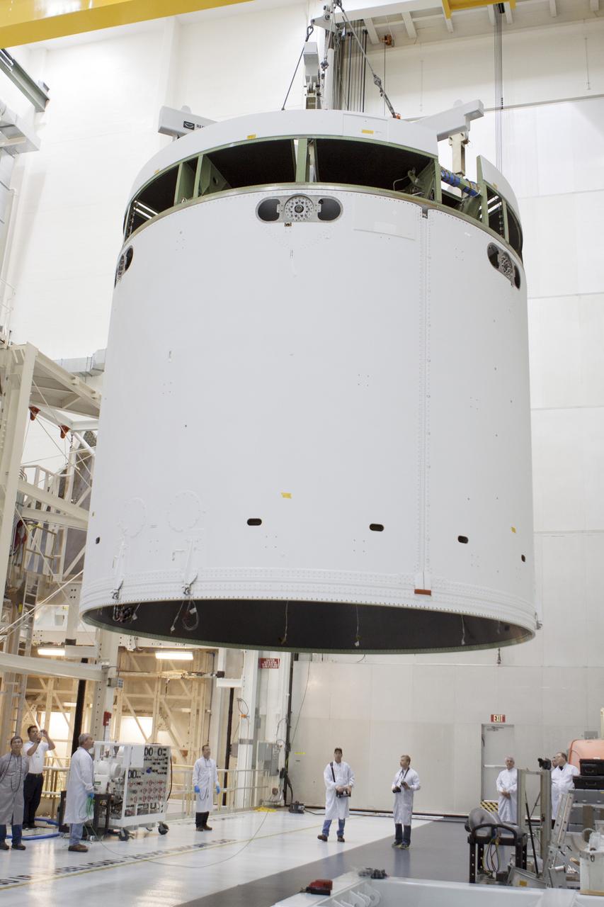 CAPE CANAVERAL, Fla. -- Inside the Operations and Checkout Building high bay at NASA's Kennedy Space Center in Florida, NASA and Lockheed Martin engineers and technicians monitor the progress as a crane is used to move the Orion service module to the Final Assembly and System Testing, or FAST, cell further down the aisle. The Orion crew module will be stacked on the service module in the FAST cell and then both modules will be put through their final system tests for Exploration Flight Test-1, or EFT-1, before rolling out of the facility for integration with the United Launch Alliance Delta IV Heavy rocket.     Orion is the exploration spacecraft designed to carry astronauts to destinations not yet explored by humans, including an asteroid and Mars. It will have emergency abort capability, sustain the crew during space travel and provide safe re-entry from deep space return velocities. The first unpiloted test flight of Orion, EFT-1, is scheduled to launch later this year atop a Delta IV rocket from Cape Canaveral Air Force Station in Florida to an altitude of 3,600 miles above the Earth's surface. The two-orbit, four-hour flight test will help engineers evaluate the systems critical to crew safety including the heat shield, parachute system and launch abort system. For more information, visit http://www.nasa.gov/orion. Photo credit: NASA/Glenn Benson