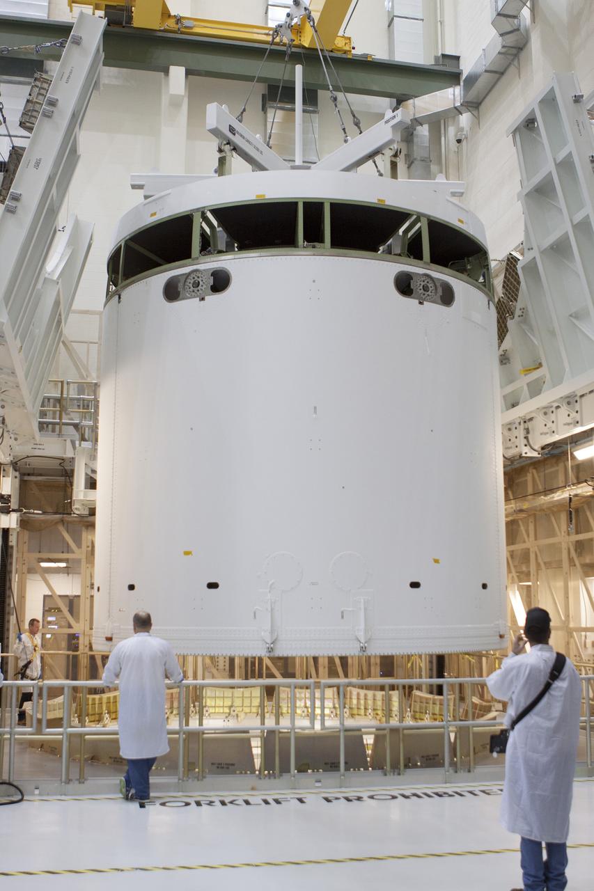 CAPE CANAVERAL, Fla. -- Inside the Operations and Checkout Building high bay at NASA's Kennedy Space Center in Florida, NASA and Lockheed Martin engineers and technicians monitor the progress as a crane lowers the Orion service module into the Final Assembly and System Testing, or FAST, cell. The Orion crew module will be stacked on the service module in the FAST cell and then both modules will be put through their final system tests for Exploration Flight Test-1, or EFT-1, before rolling out of the facility for integration with the United Launch Alliance Delta IV Heavy rocket.     Orion is the exploration spacecraft designed to carry astronauts to destinations not yet explored by humans, including an asteroid and Mars. It will have emergency abort capability, sustain the crew during space travel and provide safe re-entry from deep space return velocities. The first unpiloted test flight of Orion, EFT-1, is scheduled to launch later this year atop a Delta IV rocket from Cape Canaveral Air Force Station in Florida to an altitude of 3,600 miles above the Earth's surface. The two-orbit, four-hour flight test will help engineers evaluate the systems critical to crew safety including the heat shield, parachute system and launch abort system. For more information, visit http://www.nasa.gov/orion. Photo credit: NASA/Glenn Benson
