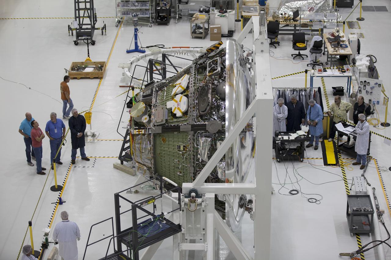 CAPE CANAVERAL, Fla. -- Inside the Operations and Checkout Building high bay at NASA's Kennedy Space Center in Florida, NASA and Lockheed Martin technicians and engineers conduct a center of gravity, or CG, test on the Orion crew module. The CG tool will measure the exact location of the vehicle's center of gravity. This test is important as it affects the handling and control characteristics of the vehicle. The Orion crew module will be stacked on the service module in the Final Assembly and System Testing, or FAST, cell and then both modules will be put through their final system tests for Exploration Flight Test-1, or EFT-1, before rolling out of the facility for integration with the United Launch Alliance Delta IV Heavy rocket.      Orion is the exploration spacecraft designed to carry astronauts to destinations not yet explored by humans, including an asteroid and Mars. It will have emergency abort capability, sustain the crew during space travel and provide safe re-entry from deep space return velocities. The first unpiloted test flight of Orion, EFT-1, is scheduled to launch later this year atop a Delta IV rocket from Cape Canaveral Air Force Station in Florida to an altitude of 3,600 miles above the Earth's surface. The two-orbit, four-hour flight test will help engineers evaluate the systems critical to crew safety including the heat shield, parachute system and launch abort system. For more information, visit http://www.nasa.gov/orion. Photo credit: NASA/Glenn Benson