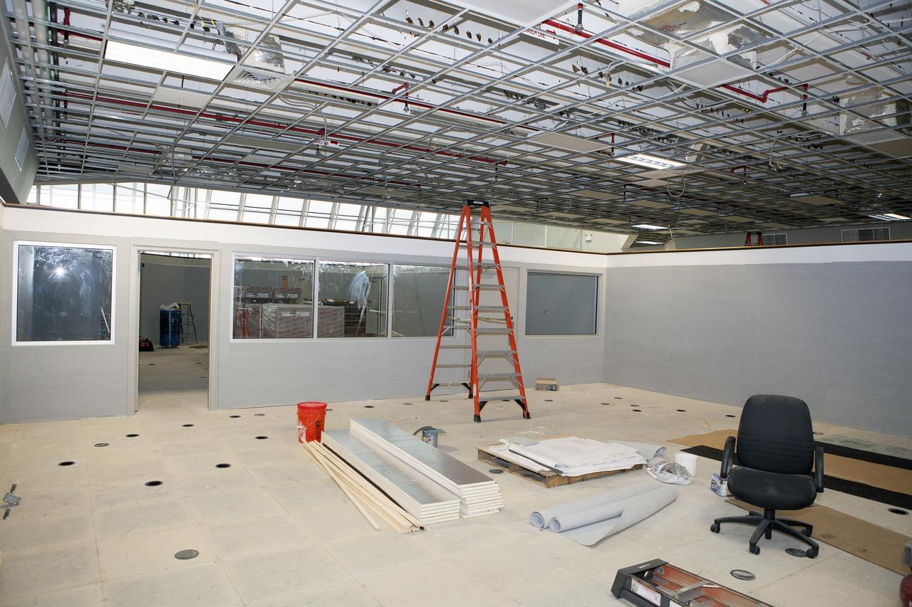 CAPE CANAVERAL, Fla. – Inside Firing Room 4 in the Launch Control Center at NASA's Kennedy Space Center in Florida, construction workers are completing the inner walls that separate the four firing rooms and the window framing and doorways are nearing completion. Preparations are underway for installation of new ceiling tiles. Three rows of upper level management consoles remain and could be used as a fifth firing room. The Ground Systems Development and Operations Program is overseeing the efforts to create a new firing room based on a multi-user concept.     The design of Firing Room 4 will incorporate five control room areas that are flexible to meet current and future NASA and commercial user requirements. The equipment and most of the consoles from Firing Room 4 were moved to Firing Room 2 for possible future reuse. Photo credit: NASA/Daniel Casper