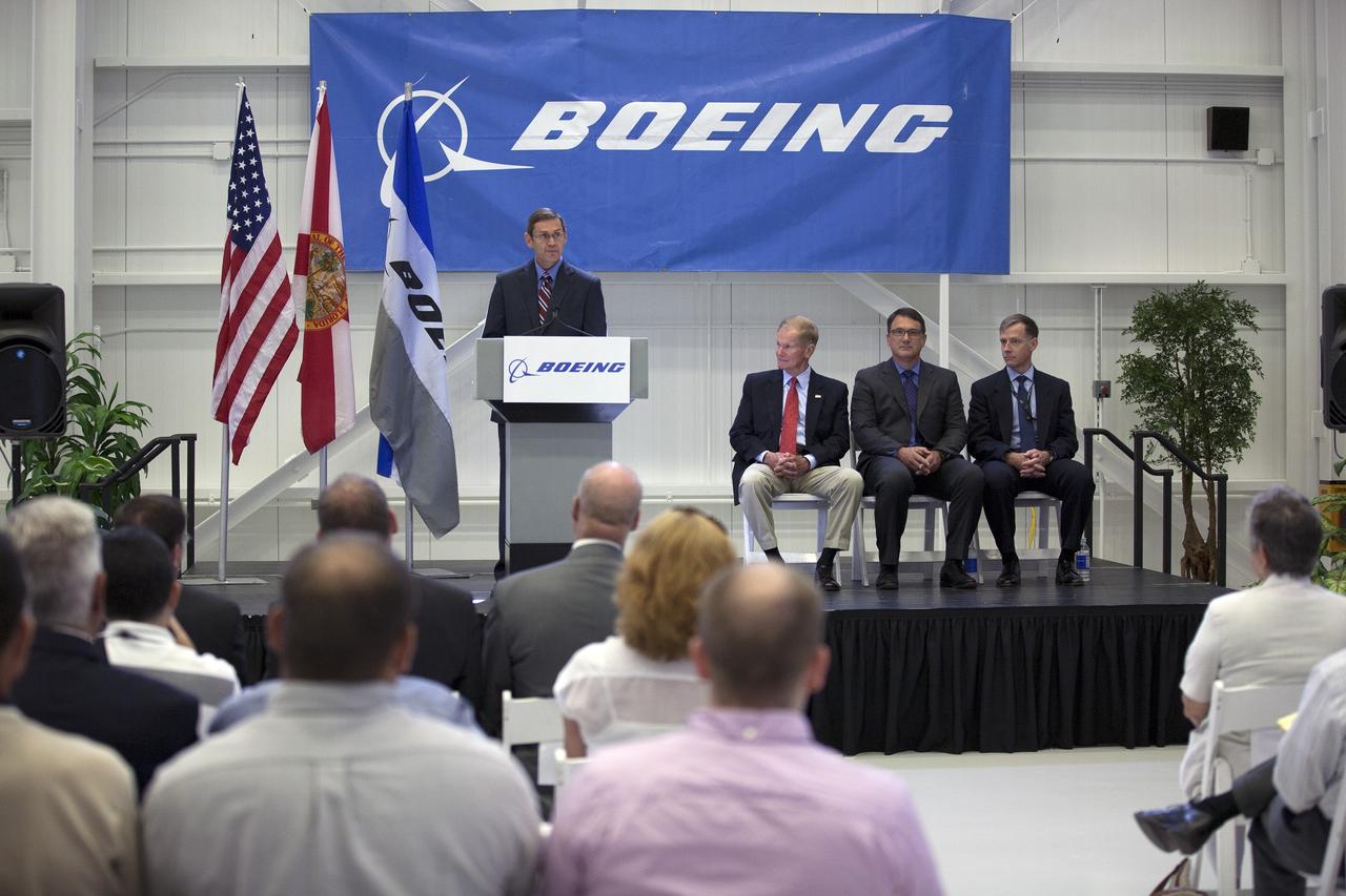 CAPE CANAVERAL, Fla. – John Elbon, The Boeing Company's vice president general manager of Boeing Space Systems, discusses the CST-100 spacecraft during a ceremony inside Orbiter Processing Facility 3 at NASA's Kennedy Space Center in Florida. Looking on are, from left, U.S. Sen. Bill Nelson of Florida, John Mulholland, Boeing's program manager for the CST-100, and Chris Ferguson, Boeing's director of Crew and Mission Operations. Photo credit: NASA/Kim Shiflett