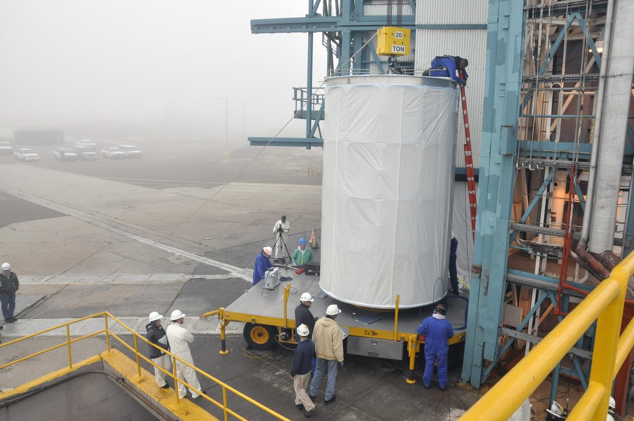 VANDENBERG AIR FORCE BASE, Calif. – NASA's Orbiting Carbon Observatory-2, or OCO-2, is connected to a 20-ton crane at the mobile service tower at Space Launch Complex 2 at Vandenberg Air Force Base in California. The spacecraft will be mated with the United Launch Alliance Delta II rocket inside the tower. Launch is scheduled for July 1. OCO-2 will collect precise global measurements of carbon dioxide in the Earth's atmosphere and provide scientists with a better idea of the chemical compound's impacts on climate change. Scientists will analyze this data to improve our understanding of the natural processes and human activities that regulate the abundance and distribution of this important atmospheric gas. To learn more about OCO-2, visit http://oco.jpl.nasa.gov. Photo credit: NASA/Randy Beaudoin