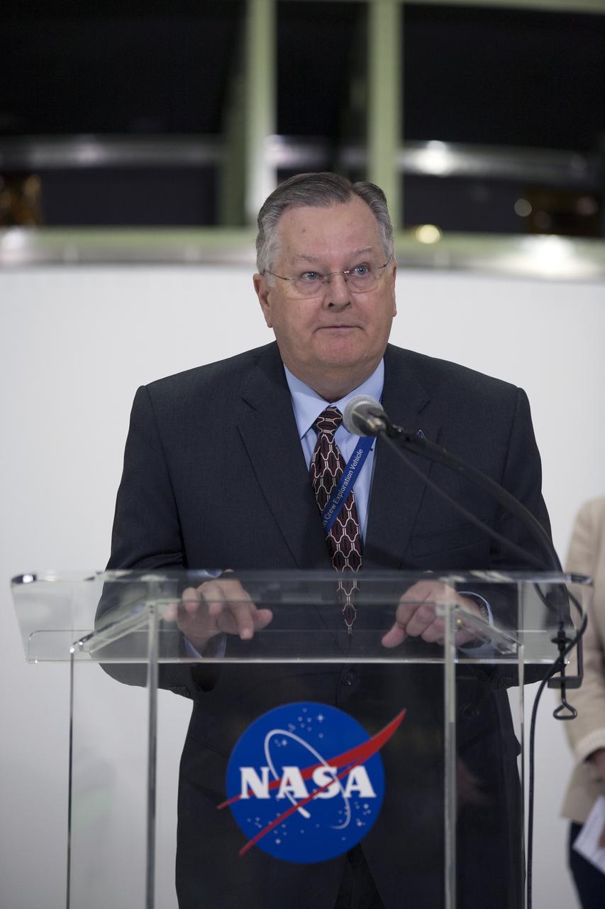 CAPE CANAVERAL, Fla. – Cleon Lacefield, Lockheed Martin Orion Program manager helps mark the T-6 months and counting to the launch of Orion on Exploration Flight Test-1, or EFT-1, inside the Operations and Checkout Building high bay at NASA's Kennedy Space Center in Florida. The crew module has been stacked on the service module in the Final Assembly and System Testing cell. EFT-1 will provide engineers with data about the heat shield's ability to protect Orion and its future crews from the 4,000-degree heat of reentry and an ocean splashdown following the spacecraft’s 20,000-mph reentry from space. Data gathered during the flight will inform decisions about design improvements on the heat shield and other Orion systems, and authenticate existing computer models and new approaches to space systems design and development. This process is critical to reducing overall risks and costs of future Orion missions.    Orion is the exploration spacecraft designed to carry astronauts to destinations not yet explored by humans, including an asteroid and Mars. It will have emergency abort capability, sustain the crew during space travel and provide safe re-entry from deep space return velocities. The first unpiloted test flight of the Orion is scheduled to launch later this year atop a Delta IV rocket from Cape Canaveral Air Force Station in Florida to an altitude of 3,600 miles above the Earth's surface. The two-orbit, four-hour flight test will help engineers evaluate the systems critical to crew safety including the heat shield, parachute system and launch abort system. For more information, visit http://www.nasa.gov/orion. Photo credit: NASA/Kim Shiflett