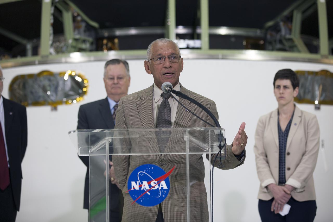 CAPE CANAVERAL, Fla. – NASA Administrator Charlie Bolden helps mark the T-6 months and counting to the launch of Orion on Exploration Flight Test-1, or EFT-1, during a visit to the Operations and Checkout Building high bay at NASA's Kennedy Space Center in Florida. To his right is Rachel Kraft, NASA Public Affairs Officer, and standing behind him is Cleon Lacefield, Lockheed Martin Orion Program manager. The crew module has been stacked on the service module in the Final Assembly and System Testing cell. EFT-1 will provide engineers with data about the heat shield's ability to protect Orion and its future crews from the 4,000-degree heat of reentry and an ocean splashdown following the spacecraft’s 20,000-mph reentry from space. Data gathered during the flight will inform decisions about design improvements on the heat shield and other Orion systems, and authenticate existing computer models and new approaches to space systems design and development. This process is critical to reducing overall risks and costs of future Orion missions.    Orion is the exploration spacecraft designed to carry astronauts to destinations not yet explored by humans, including an asteroid and Mars. It will have emergency abort capability, sustain the crew during space travel and provide safe re-entry from deep space return velocities. The first unpiloted test flight of the Orion is scheduled to launch later this year atop a Delta IV rocket from Cape Canaveral Air Force Station in Florida to an altitude of 3,600 miles above the Earth's surface. The two-orbit, four-hour flight test will help engineers evaluate the systems critical to crew safety including the heat shield, parachute system and launch abort system. For more information, visit http://www.nasa.gov/orion. Photo credit: NASA/Kim Shiflett