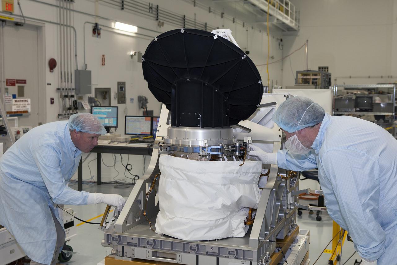 CAPE CANAVERAL, Fla. – The rotating radar antenna on NASA's International Space Station-RapidScat undergoes preflight testing in the Space Station Processing Facility at NASA's Kennedy Space Center in Florida by visiting personnel from NASA's Jet Propulsion Laboratory in California. From left are RapidScat project manager John Wirth and JPL flight technician Kieran McKay. Built at JPL, the radar scatterometer is the first scientific Earth-observing instrument designed to operate from the exterior of the space station. It will measure Earth's ocean surface wind speed and direction, providing data to be used in weather and marine forecasting. ISS-RapidScat will be delivered to the station on the SpaceX-4 commercial cargo resupply flight targeted for August 2014. For more information, visit http://www.jpl.nasa.gov/missions/iss-rapidscat. Photo credit: NASA/Daniel Casper