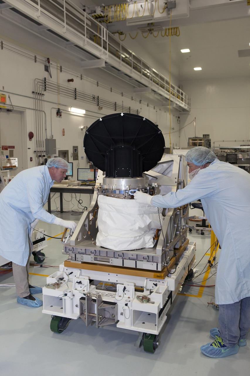 CAPE CANAVERAL, Fla. – Personnel from NASA's Jet Propulsion Laboratory JPL in California check the instruments on NASA's International Space Station-RapidScat during testing of its rotating radar antenna in the Space Station Processing Facility at NASA's Kennedy Space Center in Florida. From left are RapidScat project manager John Wirth and JPL flight technician Kieran McKay. Built at JPL, the radar scatterometer is the first scientific Earth-observing instrument designed to operate from the exterior of the space station. It will measure Earth's ocean surface wind speed and direction, providing data to be used in weather and marine forecasting. ISS-RapidScat will be delivered to the station on the SpaceX-4 commercial cargo resupply flight targeted for August 2014. For more information, visit http://www.jpl.nasa.gov/missions/iss-rapidscat. Photo credit: NASA/Daniel Casper