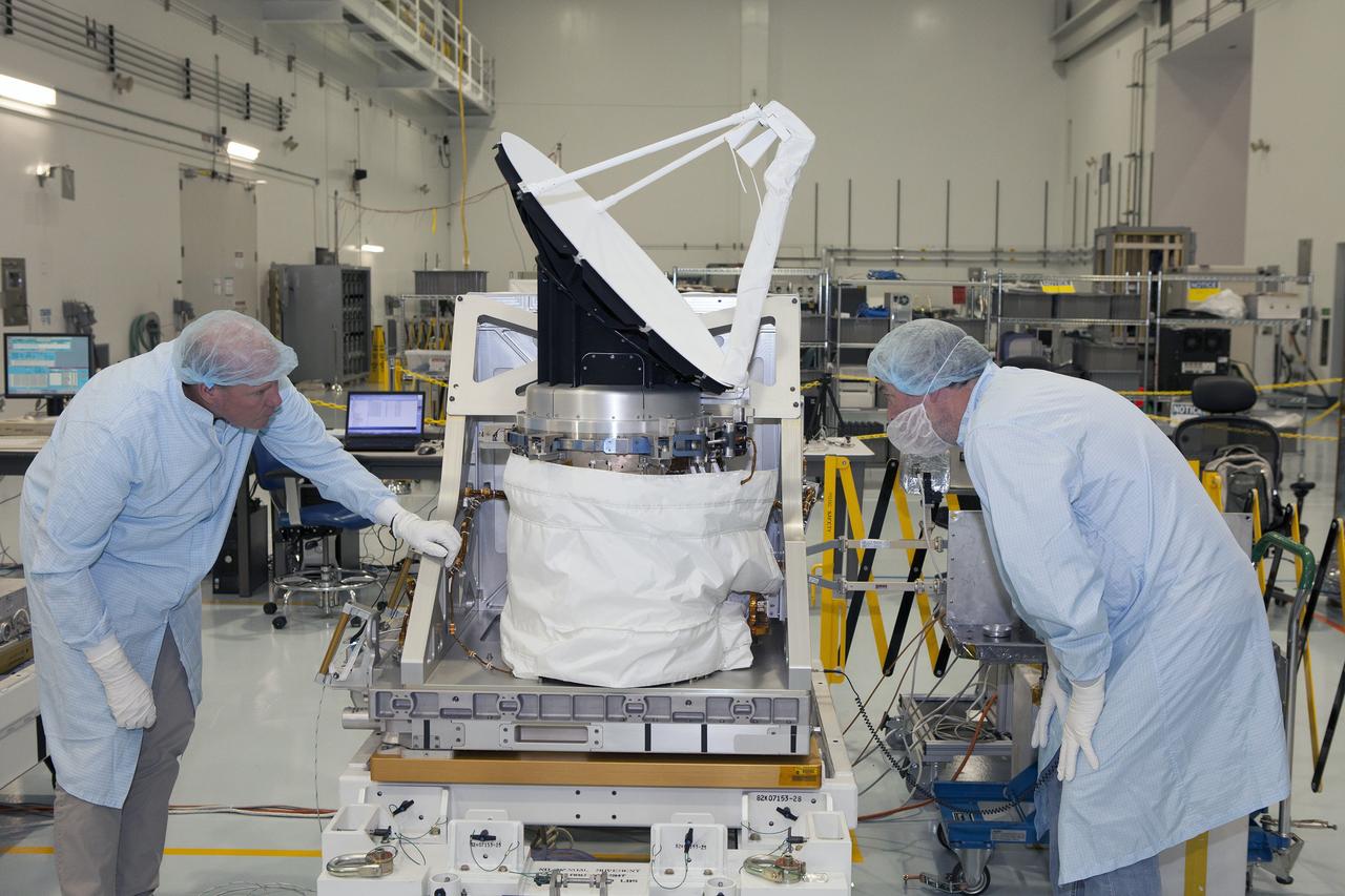 CAPE CANAVERAL, Fla. – Personnel from NASA's Jet Propulsion Laboratory JPL in California double-check instrument performance on NASA's International Space Station-RapidScat as testing of its rotating radar antenna is conducted in the Space Station Processing Facility at NASA's Kennedy Space Center in Florida. From left are RapidScat project manager John Wirth and JPL flight technician Kieran McKay. Built at JPL, the radar scatterometer is the first scientific Earth-observing instrument designed to operate from the exterior of the space station. It will measure Earth's ocean surface wind speed and direction, providing data to be used in weather and marine forecasting. ISS-RapidScat will be delivered to the station on the SpaceX-4 commercial cargo resupply flight targeted for August 2014. For more information, visit http://www.jpl.nasa.gov/missions/iss-rapidscat. Photo credit: NASA/Daniel Casper