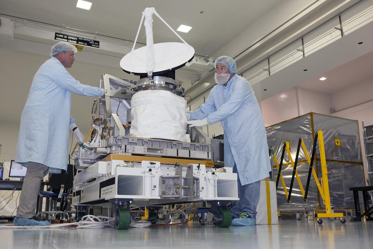 CAPE CANAVERAL, Fla. – Personnel from NASA's Jet Propulsion Laboratory JPL in California reposition NASA's International Space Station-RapidScat during testing of its rotating radar antenna in the Space Station Processing Facility at NASA's Kennedy Space Center in Florida. From left are RapidScat project manager John Wirth and JPL flight technician Kieran McKay. Built at JPL, the radar scatterometer is the first scientific Earth-observing instrument designed to operate from the exterior of the space station. It will measure Earth's ocean surface wind speed and direction, providing data to be used in weather and marine forecasting. ISS-RapidScat will be delivered to the station on the SpaceX-4 commercial cargo resupply flight targeted for August 2014. For more information, visit http://www.jpl.nasa.gov/missions/iss-rapidscat. Photo credit: NASA/Daniel Casper