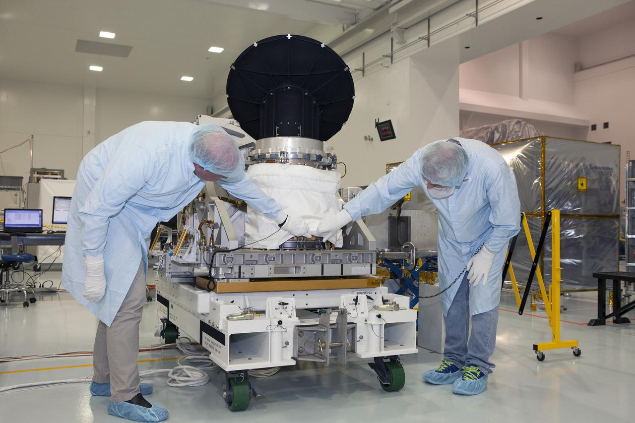CAPE CANAVERAL, Fla. – Personnel from NASA's Jet Propulsion Laboratory JPL in California verify that NASA's International Space Station-RapidScat is performing properly during testing of its rotating radar antenna in the Space Station Processing Facility at NASA's Kennedy Space Center in Florida. From left are RapidScat project manager John Wirth and JPL flight technician Kieran McKay. Built at JPL, the radar scatterometer is the first scientific Earth-observing instrument designed to operate from the exterior of the space station. It will measure Earth's ocean surface wind speed and direction, providing data to be used in weather and marine forecasting. ISS-RapidScat will be delivered to the station on the SpaceX-4 commercial cargo resupply flight targeted for August 2014. For more information, visit http://www.jpl.nasa.gov/missions/iss-rapidscat. Photo credit: NASA/Daniel Casper
