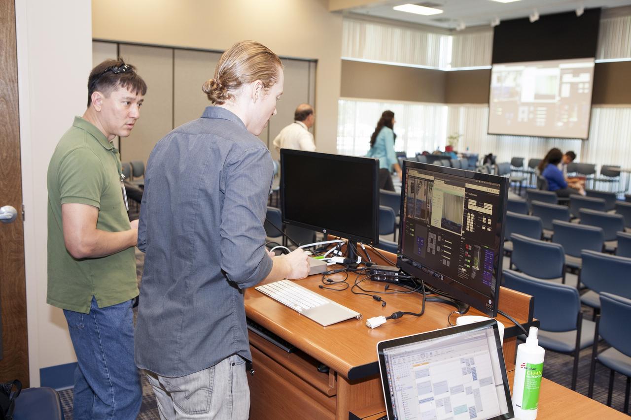 CAPE CANAVERAL, Fla. -- At the Kennedy Space Center in Florida, students from the University of Colorado Boulder demonstrated a robotic capability for growing a variety of plants in a deep-space habitat. Daniel Zukowski, a University of Colorado Boulder graduate student, right, and Morgan Simpson of the NASA Ground Processing Directorate, check computer displays during a presentation of the team's entry in the eXploration HABitat X-Hab Academic Innovation Challenge. In their concept called "Plants Anywhere: Plants Growing in Free Habitat Spaces," their approach calls for robotically tended plants to be scattered in any available space in a deep-space habitat instead of an area set aside just for vegetation.      X-Hab Academic Innovation Challenge is a university-level activity designed to engage and retain students in science, technology, engineering and math, or STEM, disciplines. NASA will directly benefit from the effort by sponsoring the development of innovative habitat concepts from universities which may result in innovative ideas and solutions that could be applied to exploration habitats. For more: http://www.nasa.gov/exploration/technology/deep_space_habitat/xhab/ Photo credit: NASA/Daniel Casper