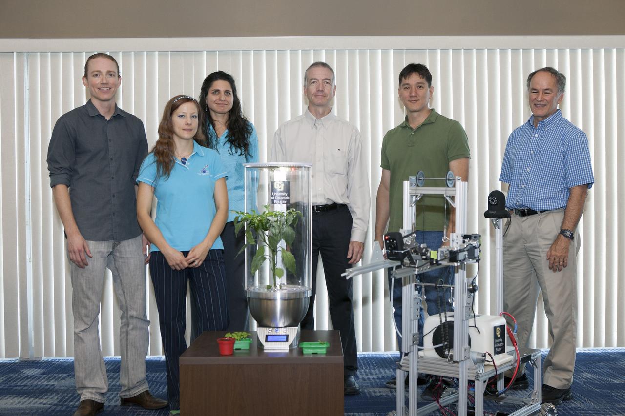 CAPE CANAVERAL, Fla. -- At the Kennedy Space Center in Florida, University of Colorado Boulder graduate students Heather Hava, far left, and Daniel Zukowski, second from the left, pose with a computerized SmartPot, or SPOT, which could be used to grow plants in a deep-space habitat. To the right of the SPOT is a Remotely Operated Gardening Rover, or ROGR. The system is being developed by the graduate students participating in the eXploration HABitat X-Hab Academic Innovation Challenge. From the left are Zukowski, Hava, Gioia Massa of the NASA International Space Station Ground Processing and Research Project Office, Tracy Gill of the NASA Center Planning and Development Directorate, Morgan Simpson of the NASA Ground Processing Directorate, and Ray Wheeler of the NASA Engineering and Technology Directorate.      X-Hab Academic Innovation Challenge is a university-level activity designed to engage and retain students in science, technology, engineering and math, or STEM, disciplines. NASA will directly benefit from the effort by sponsoring the development of innovative habitat concepts from universities which may result in innovative ideas and solutions that could be applied to exploration habitats. For more: http://www.nasa.gov/exploration/technology/deep_space_habitat/xhab/ Photo credit: NASA/Daniel Casper