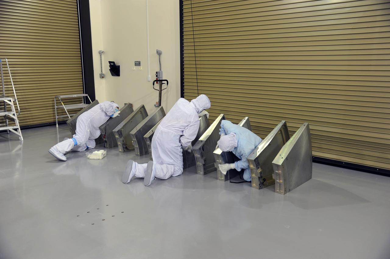 VANDENBERG AIR FORCE BASE, Calif. – Technicians clean some of the hardware for NASA's Orbiting Carbon Observatory-2 mission, or OCO-2, in the Astrotech Payload Processing Facility on Vandenberg Air Force Base in California to ensure that the spacecraft is not contaminated prior to its transport to Space Launch Complex 2 for enclosure in the Delta II payload fairing.    Launch aboard a United Launch Alliance Delta II rocket is scheduled for 5:56 a.m. EDT on July 1.  OCO-2 is NASA’s first mission dedicated to studying atmospheric carbon dioxide, the leading human-produced greenhouse gas driving changes in Earth’s climate. OCO-2 will provide a new tool for understanding the human and natural sources of carbon dioxide emissions and the natural "sinks" that absorb carbon dioxide and help control its buildup. The observatory will measure the global geographic distribution of these sources and sinks and study their changes over time. To learn more about OCO-2, visit http://oco.jpl.nasa.gov.  Photo credit: NASA/30th Space Wing, U.S. Air Force