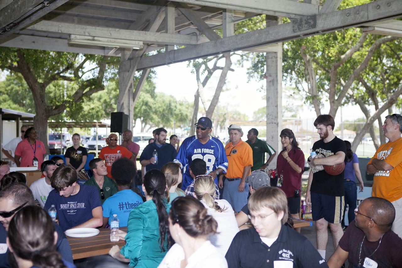 CAPE CANAVERAL, Fla. – Kennedy Space Center Associate Director Kelvin Manning, in the blue Air Force shirt, speaks to Pathways and summer interns at the KARS Park I facility near the center. High school, undergraduate and graduate students participated in a team building exercise and received advice on leadership skills and working together from Kennedy's senior management.    About 160 students are working and gaining experience in many of the directorates and programs during their time at Kennedy. Photo credit: NASA/Daniel Casper