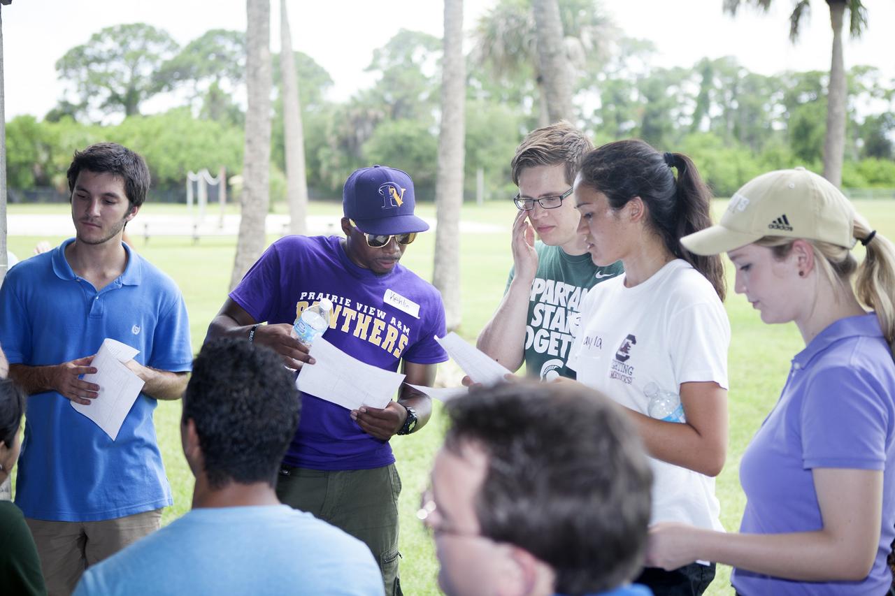 CAPE CANAVERAL, Fla. – Kennedy Space Center Pathways and summer intern students participate in a team building exercise at the KARS Park I facility near the center. High school, undergraduate and graduate students also received advice on leadership skills and working together from Kennedy's senior management, including Center Director Bob Cabana and Associate Director Kelvin Manning.    About 160 students are working and gaining experience in many of the directorates and programs during their time at Kennedy. Photo credit: NASA/Daniel Casper