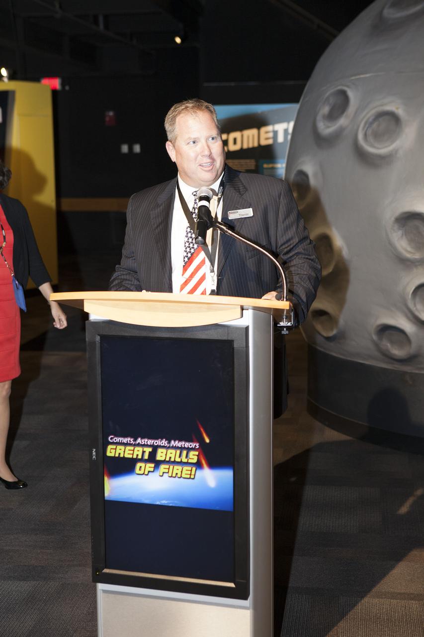 CAPE CANAVERAL, Fla. – Therrin Protze, chief operating officer with Delaware North Parks and Resorts at NASA's Kennedy Space Center Visitor Complex in Florida, welcomes guests to the grand opening of the Great Balls of Fire exhibit.    Great Balls of Fire shares the story of the origins of our solar system, asteroids and comets and their possible impacts and risks. The 1,500-square-foot exhibit, located in the East Gallery of the IMAX theatre at the visitor complex, features several interactive displays, real meteorites and replica asteroid models. The exhibit is a production of The Space Science Institute's National Center for Interactive Learning. It is a traveling exhibition that also receives funding from NASA and the National Science Foundation. Photo credit: NASA/Daniel Casper