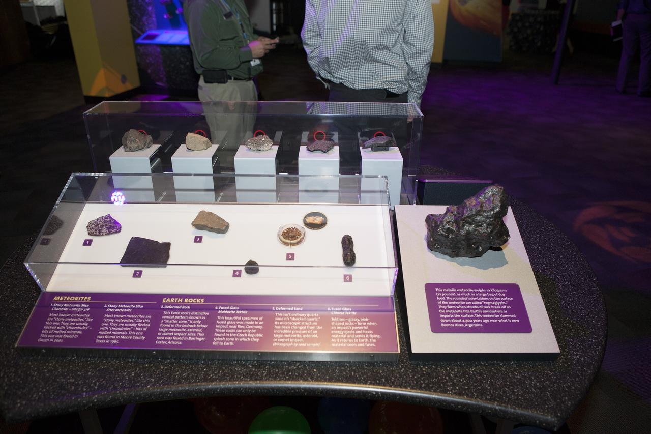 CAPE CANAVERAL, Fla. – Samples of Earth rocks and real meteorites are featured in an interactive display at the new Great Balls of Fire exhibit at NASA’s Kennedy Space Center Visitor Complex in Florida. The grand opening featured remarks by former NASA astronaut Tom Jones, and Therrin Protze, chief operating officer at Delaware North Parks and Resorts at the visitor complex.    Great Balls of Fire shares the story of the origins of our solar system, asteroids and comets and their possible impacts and risks. The 1,500-square-foot exhibit, located in the East Gallery of the IMAX theatre at the visitor complex, features several interactive displays, real meteorites and replica asteroid models. The exhibit is a production of The Space Science Institute's National Center for Interactive Learning. It is a traveling exhibition that also receives funding from NASA and the National Science Foundation. Photo credit: NASA/Daniel Casper