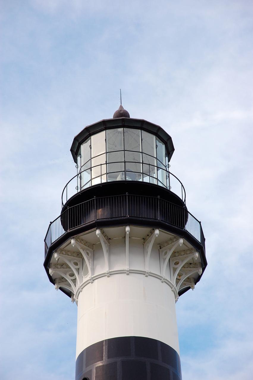 CAPE CANAVERAL, Fla. -- The U.S. Coast Guard operates the beacon of the historic Cape Canaveral Light as an active navigational aid. The lighthouse resides on Cape Canaveral Air Force Station in Florida and is owned by the U.S. Air Force. The first lighthouse on Cape Canaveral was built near the tip of the Cape in 1848. The structure was only about 60 feet high with a rather dim light powered by whale oil. In 1859, work began nearby on a new, taller iron structure. Construction was halted during the Civil War, and the lighthouse was not finished until 1868. The structure, with a brick lining inside its iron exterior, was painted with its "daymark" black and white horizontal bands in 1873 to make it easier to identify during the day as a navigation point. Between 1892 and 1894, the lighthouse was dismantled and moved to a new location about a mile from the coast, where it stands today. For more information on the lighthouse, visit http://www.nasa.gov/centers/kennedy/about/history/lighthouse.html. Photo credit: NASA/Ben Smegelsky