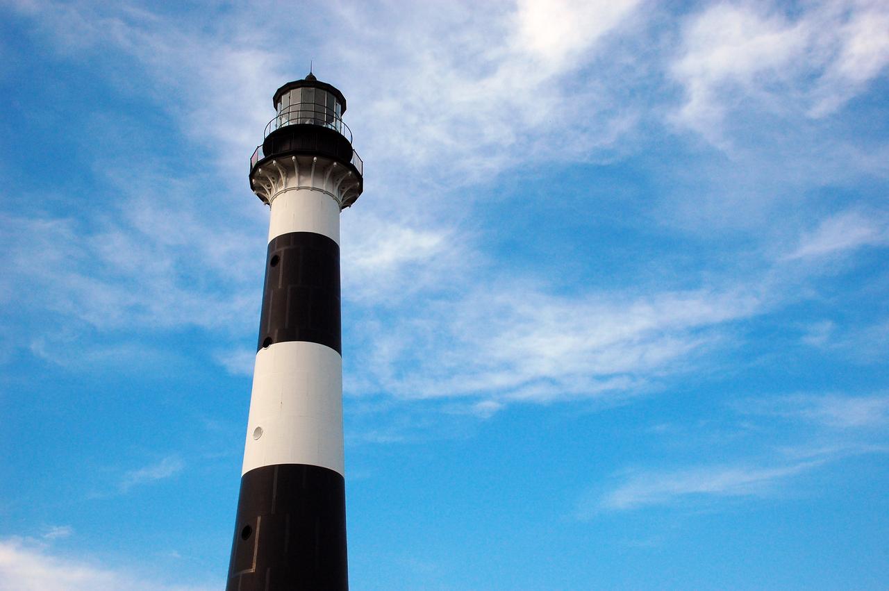 CAPE CANAVERAL, Fla. -- The historic Cape Canaveral Light on Cape Canaveral Air Force Station in Florida serves as a navigational aid for boaters and fishing interests along Florida's Atlantic coast. The U.S. Coast Guard operates the lighthouse's beacon the U.S. Air Force owns the lighthouse. The first lighthouse on Cape Canaveral was built near the tip of the Cape in 1848. The structure was only about 60 feet high with a rather dim light powered by whale oil. In 1859, work began nearby on a new, taller iron structure. Construction was halted during the Civil War, and the lighthouse was not finished until 1868. The structure, with a brick lining inside its iron exterior, was painted with its "daymark" black and white horizontal bands in 1873 to make it easier to identify during the day as a navigation point. Between 1892 and 1894, the lighthouse was dismantled and moved to a new location about a mile from the coast, where it stands today. For more information on the lighthouse, visit http://www.nasa.gov/centers/kennedy/about/history/lighthouse.html. Photo credit: NASA/Ben Smegelsky