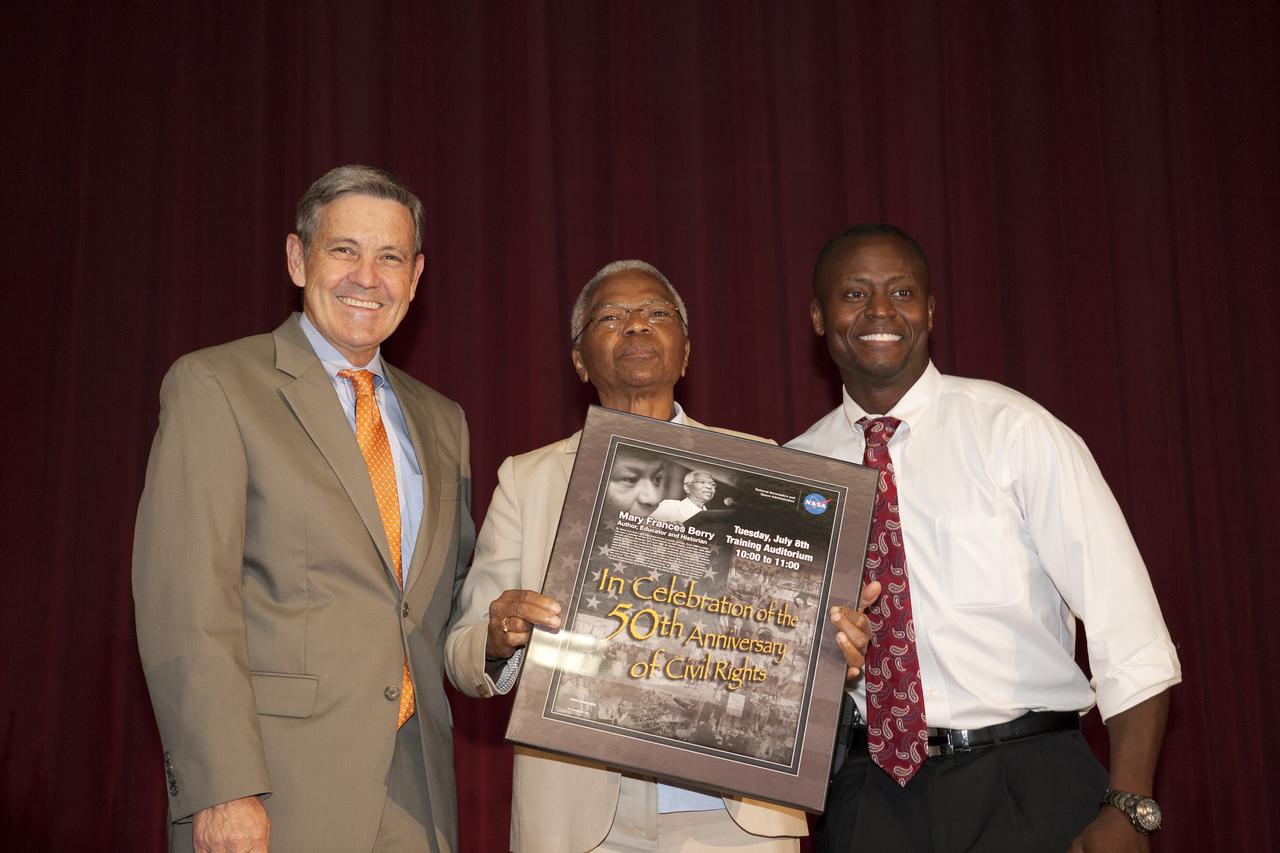 CAPE CANAVERAL, Fla. -- In the KSC Training Auditorium at NASA's Kennedy Space Center in Florida, Dr. Mary Frances Berry, center, accepts a framed poster announcing her appearance from Center Director Robert Cabana, left, who made the opening remarks, and Yves Lamothe, right, transition manager for the Ground Systems Development and Operations Program, the master of ceremonies.    Berry served as the assistant secretary for education in the U.S. Department of Health, Education and Welfare HEW between 1977 and 1980. From 1980 to 2004, she was a member of the U.S. Commission on Civil Rights, serving as chair from 1993 to 2004. Among Berry's many honors are the NAACP's Roy Wilkins Award, the Rosa Parks Award of the Southern Christian Leadership Conference, and the Ebony Magazine Black Achievement Award. She is one of 75 women featured in the book "I Dream a World: Portraits of Black Women Who Changed America." Sienna College Research Institute and the Women's Hall of Fame also designated her one of "America's Women of the Century."  The event was presented by Kennedy's Office of Diversity and Equal Opportunity. For more information about Kennedy Space Center, visit http://www.nasa.gov/kennedy. Photo credit: NASA/Kim Shiflett