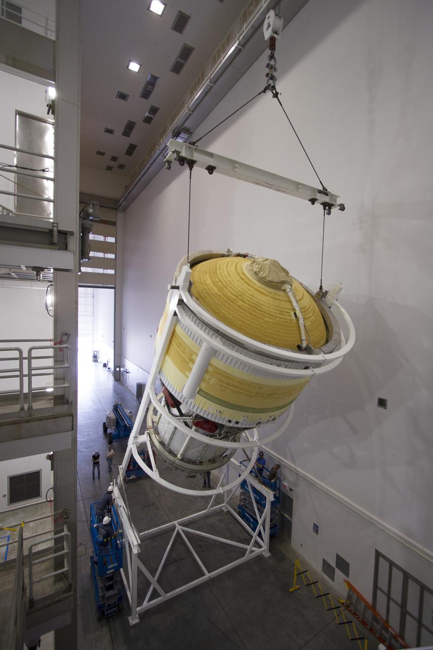 CAPE CANAVERAL, Fla. – Inside the Delta Operations Center near Space Launch Complex 37 on Cape Canaveral Air Force Station in Florida, the second stage for the United Launch Alliance Delta IV Heavy for Exploration Flight Test-1, or EFT-1, is being lifted by crane in its cradle for the move to a test cell. At the Horizontal Integration Facility, all three booster stages will be processed and checked out before being moved to the nearby launch pad and hoisted into position. During the EFT-1 mission, Orion will travel farther into space than any human spacecraft has gone in more than 40 years. The data gathered during the flight will influence design decisions, validate existing computer models and innovative new approaches to space systems development, as well as reduce overall mission risks and costs for later Orion flights. Liftoff of Orion on EFT-1 is planned for fall 2014. Photo credit: NASA/Frankie Martin