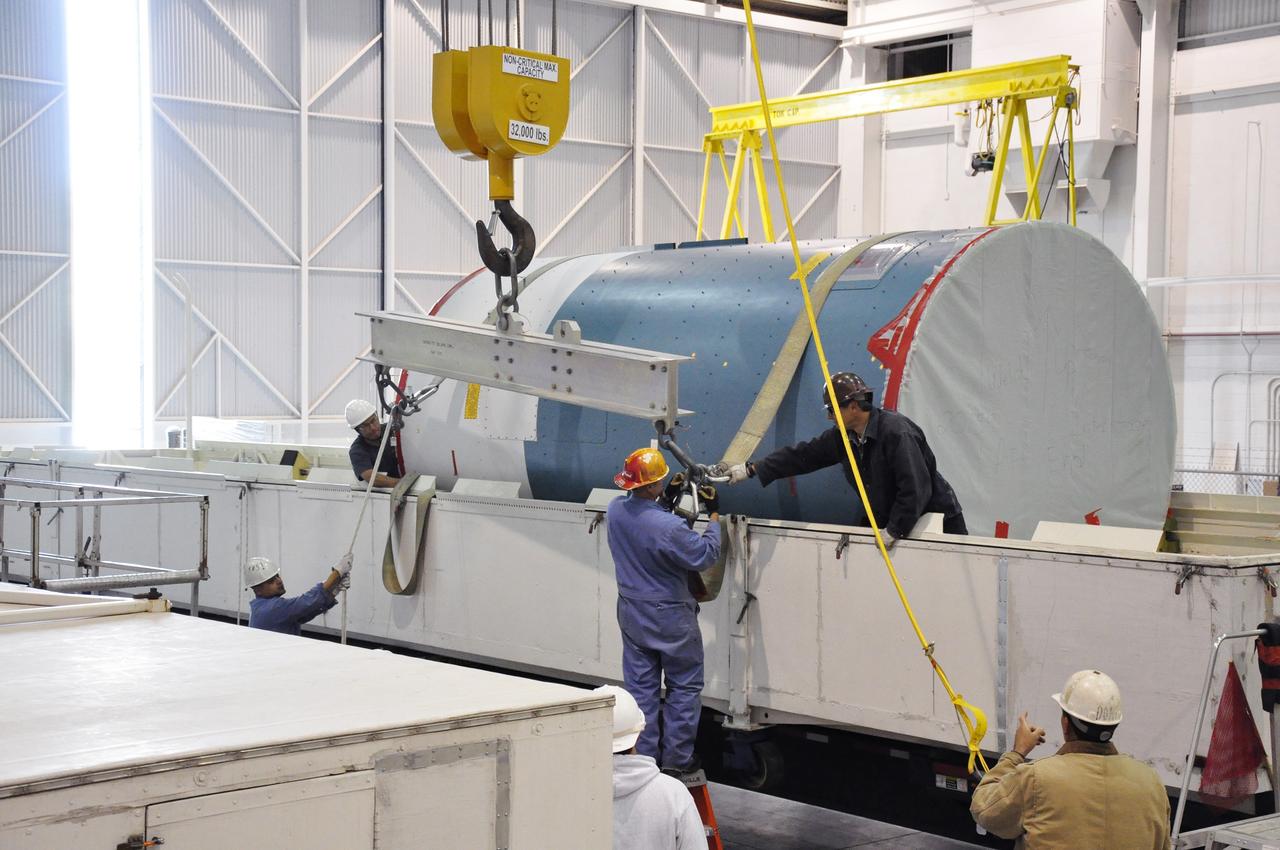 VANDENBERG AIR FORCE BASE, Calif. – Workers attach the canister containing the interstage adapter, or ISA, for NASA's Soil Moisture Active Passive mission, or SMAP, to a lifting device in the high bay of the Building 836 hangar on south Vandenberg Air Force Base in California.    A United Launch Alliance Delta II rocket will loft SMAP into orbit from Vandenberg's Space Launch Complex 2. The ISA connects the Delta II first and second stages and encloses the second stage engine and thrust section. The spacecraft will provide global measurements of soil moisture and its freeze/thaw state. These measurements will be used to enhance understanding of processes that link the water, energy and carbon cycles, and to extend the capabilities of weather and climate prediction models. The data returned also will be used to quantify net carbon flux in boreal landscapes and to develop improved flood prediction and drought monitoring capabilities. Launch is scheduled for November 2014. To learn more about SMAP, visit http://smap.jpl.nasa.gov.  Photo credit: NASA/Randy Beaudoin