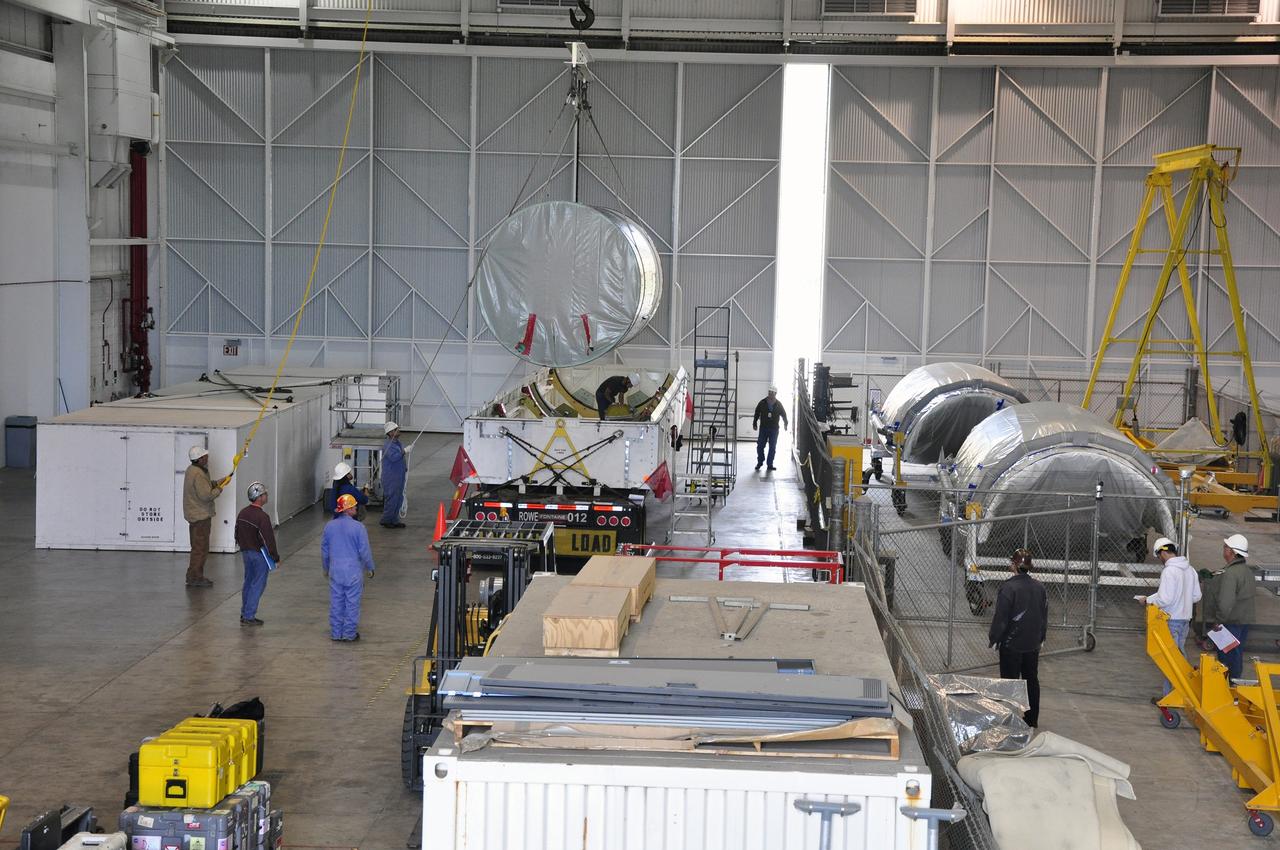 VANDENBERG AIR FORCE BASE, Calif. – The canister containing the interstage adapter, or ISA, for NASA's Soil Moisture Active Passive mission, or SMAP, is lifted out of its transportation trailer in the high bay of the Building 836 hangar on south Vandenberg Air Force Base in California.    A United Launch Alliance Delta II rocket will loft SMAP into orbit from Vandenberg's Space Launch Complex 2. The ISA connects the Delta II first and second stages and encloses the second stage engine and thrust section. The spacecraft will provide global measurements of soil moisture and its freeze/thaw state. These measurements will be used to enhance understanding of processes that link the water, energy and carbon cycles, and to extend the capabilities of weather and climate prediction models. The data returned also will be used to quantify net carbon flux in boreal landscapes and to develop improved flood prediction and drought monitoring capabilities. Launch is scheduled for November 2014. To learn more about SMAP, visit http://smap.jpl.nasa.gov.  Photo credit: NASA/Randy Beaudoin