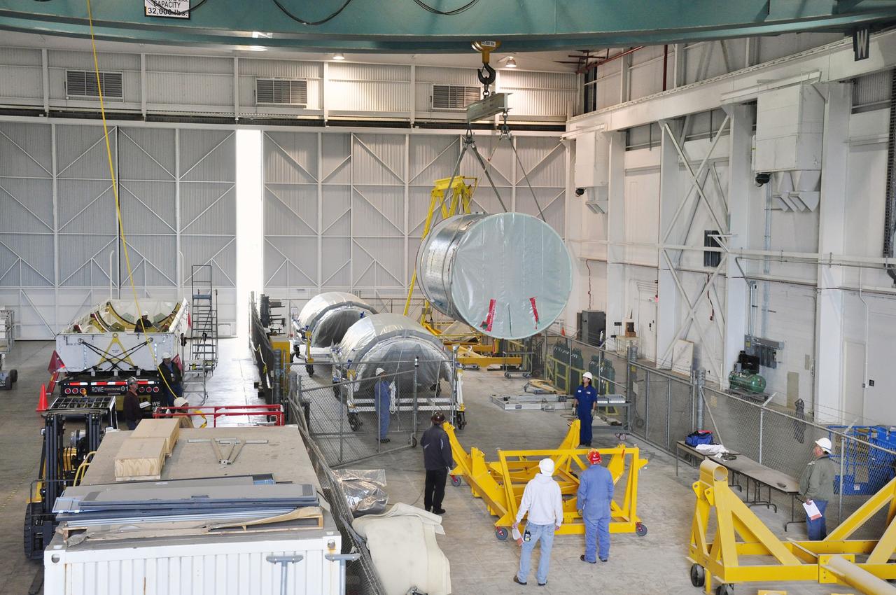 VANDENBERG AIR FORCE BASE, Calif. – The canister containing the interstage adapter, or ISA, for NASA's Soil Moisture Active Passive mission, or SMAP, glides toward a flight hardware cradle in the high bay of the Building 836 hangar on south Vandenberg Air Force Base in California.     A United Launch Alliance Delta II rocket will loft SMAP into orbit from Vandenberg's Space Launch Complex 2. The ISA connects the Delta II first and second stages and encloses the second stage engine and thrust section. The spacecraft will provide global measurements of soil moisture and its freeze/thaw state. These measurements will be used to enhance understanding of processes that link the water, energy and carbon cycles, and to extend the capabilities of weather and climate prediction models. The data returned also will be used to quantify net carbon flux in boreal landscapes and to develop improved flood prediction and drought monitoring capabilities. Launch is scheduled for November 2014. To learn more about SMAP, visit http://smap.jpl.nasa.gov.  Photo credit: NASA/Randy Beaudoin