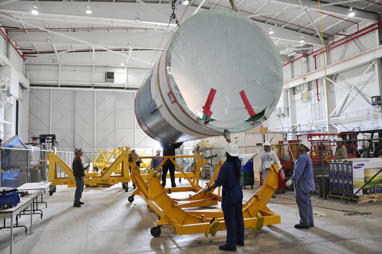 VANDENBERG AIR FORCE BASE, Calif. – Workers lower the canister containing the interstage adapter, or ISA, for NASA's Soil Moisture Active Passive mission, or SMAP, into a flight hardware cradle in the high bay of the Building 836 hangar on south Vandenberg Air Force Base in California.    A United Launch Alliance Delta II rocket will loft SMAP into orbit from Vandenberg's Space Launch Complex 2. The ISA connects the Delta II first and second stages and encloses the second stage engine and thrust section. The spacecraft will provide global measurements of soil moisture and its freeze/thaw state. These measurements will be used to enhance understanding of processes that link the water, energy and carbon cycles, and to extend the capabilities of weather and climate prediction models. The data returned also will be used to quantify net carbon flux in boreal landscapes and to develop improved flood prediction and drought monitoring capabilities. Launch is scheduled for November 2014. To learn more about SMAP, visit http://smap.jpl.nasa.gov.  Photo credit: NASA/Randy Beaudoin
