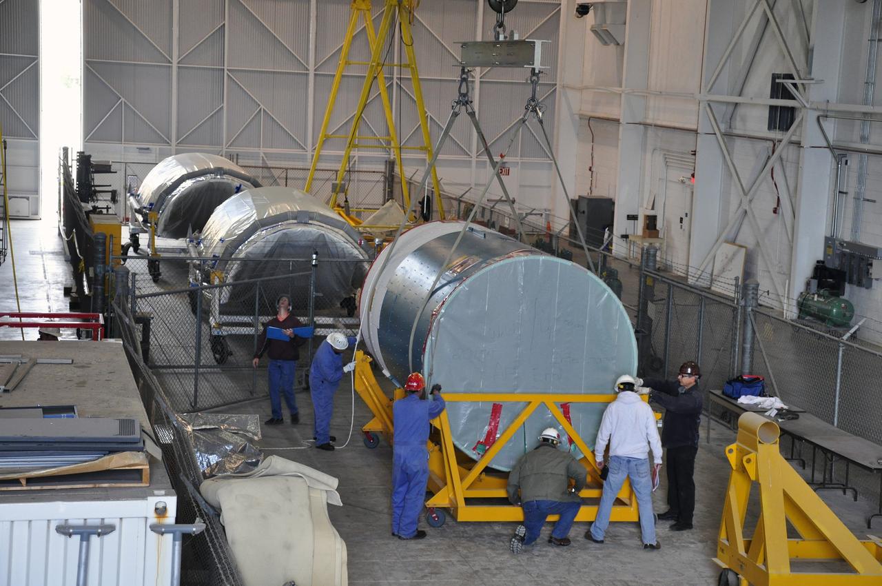 VANDENBERG AIR FORCE BASE, Calif. – Workers secure the canister containing the interstage adapter, or ISA, for NASA's Soil Moisture Active Passive mission, or SMAP, into a flight hardware cradle in the high bay of the Building 836 hangar on south Vandenberg Air Force Base in California.    A United Launch Alliance Delta II rocket will loft SMAP into orbit from Vandenberg's Space Launch Complex 2. The ISA connects the Delta II first and second stages and encloses the second stage engine and thrust section. The spacecraft will provide global measurements of soil moisture and its freeze/thaw state. These measurements will be used to enhance understanding of processes that link the water, energy and carbon cycles, and to extend the capabilities of weather and climate prediction models. The data returned also will be used to quantify net carbon flux in boreal landscapes and to develop improved flood prediction and drought monitoring capabilities. Launch is scheduled for November 2014. To learn more about SMAP, visit http://smap.jpl.nasa.gov.  Photo credit: NASA/Randy Beaudoin