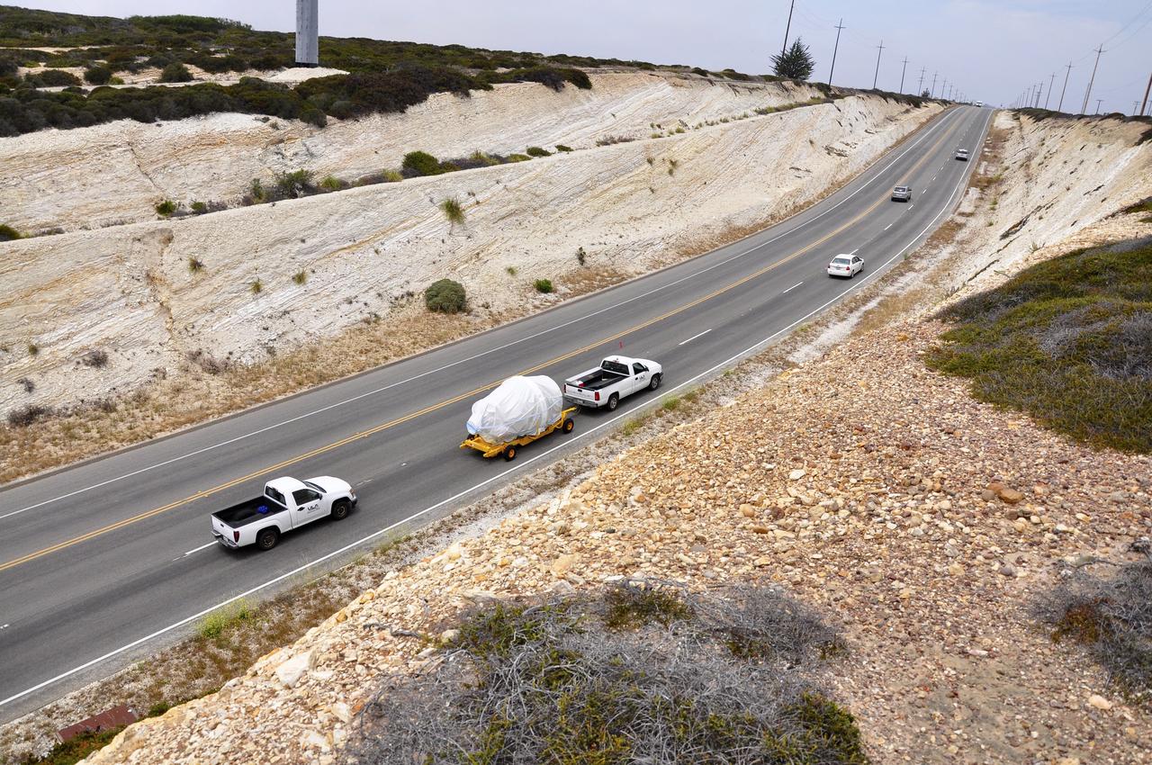 VANDENBERG AIR FORCE BASE, Calif. – The second stage, or upper stage, of a United Launch Alliance Delta II rocket is towed along the roadway from Building 836 to the Horizontal Processing Facility at Space Launch Complex 2 on Vandenberg Air Force Base in California. The Delta II rocket will be used to deliver NASA's Soil Moisture Active Passive mission, or SMAP, into orbit. SMAP will provide global measurements of soil moisture and its freeze/thaw state. These measurements will be used to enhance understanding of processes that link the water, energy and carbon cycles, and to extend the capabilities of weather and climate prediction models. SMAP data also will be used to quantify net carbon flux in boreal landscapes and to develop improved flood prediction and drought monitoring capabilities. Launch is scheduled for November 2014. To learn more about SMAP, visit http://smap.jpl.nasa.gov. Photo credit: NASA/Randy Beaudoin