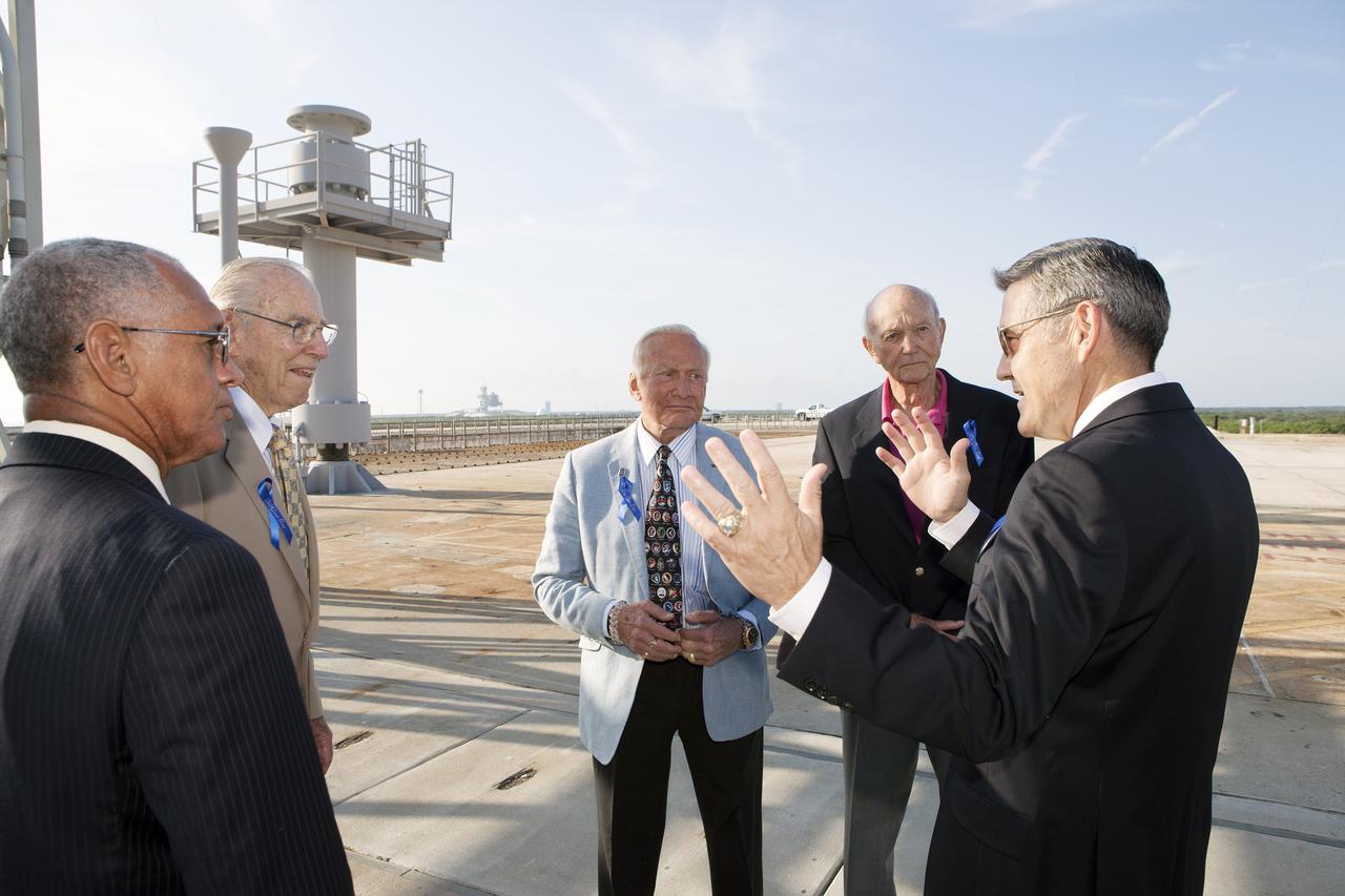 CAPE CANAVERAL, Fla. -- At the Kennedy Space Center in Florida, Center Director Bob Cabana, at right, briefs Apollo astronauts on the changes underway to Launch Pad 39B. From left are NASA administrator Charles Bolden, Apollo astronauts Jim Lovell, Buzz Aldrin and Mike Collins, and Cabana. The pad is being modified to support the agency's new Orion spacecraft which will lift off atop the Space Launch System rocket. Orion is designed to take humans farther than they’ve ever gone before, serving as the exploration vehicle that will carry astronauts to deep space and sustain the crew during travel to destinations such as an asteroid or Mars. The visit of the former astronauts was part of NASA's 45th anniversary celebration of the Apollo 11 moon landing. As the world watched, Neil Armstrong and Aldrin landed in the moon's Sea of Tranquility aboard the lunar module Eagle on July 20, 1969. Meanwhile, crewmate Collins orbited above in the command module Columbia. For more, visit http://www.nasa.gov/press/2014/july/nasa-honors-historic-first-moon-landing-eyes-first-mars-mission. Photo credit: NASA/Kim Shiflett
