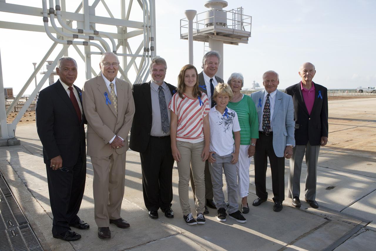 CAPE CANAVERAL, Fla. -- At the Kennedy Space Center in Florida, NASA officials and Apollo astronauts visiting Launch Pad 39B with their families and friends preserve the moment with a group portrait. The group was at Kennedy for a ceremony renaming the Operations and Checkout Building for Apollo 11 astronaut Neil Armstrong, the first person to set foot on the moon. From left are NASA Administrator Charles Bolden, Apollo astronaut Jim Lovell, Neil's son Mark Armstrong, Neil's granddaughter Lily Armstrong, Neil's son Rick Armstrong, Neil's grandson Bryce Armstrong, Neil's former wife Janet Armstrong, Apollo 11 moonwalker Buzz Aldrin, and Apollo 11 command module pilot Michael Collins. The pad is being modified to support the agency's new Orion spacecraft which will lift off atop the Space Launch System rocket. Orion is designed to take humans farther than they’ve ever gone before, serving as the exploration vehicle that will carry astronauts to deep space and sustain the crew during travel to destinations such as an asteroid or Mars.      The visit of the former astronauts was part of NASA's 45th anniversary celebration of the Apollo 11 moon landing. As the world watched, Neil Armstrong and Neil Aldrin landed in the moon's Sea of Tranquility aboard the lunar module Eagle on July 20, 1969. Meanwhile, crewmate Michael Collins orbited above in the command module Columbia. For more, visit http://www.nasa.gov/press/2014/july/nasa-honors-historic-first-moon-landing-eyes-first-mars-mission. Photo credit: NASA/Kim Shiflett
