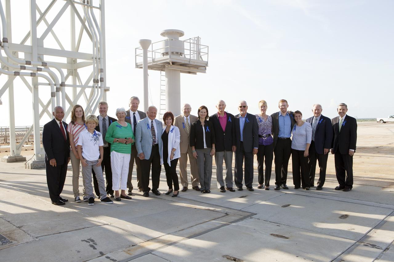 CAPE CANAVERAL, Fla. -- At NASA's Kennedy Space Center in Florida, NASA officials and Apollo astronauts visiting Launch Pad 39B with their families and friends preserve the moment with a group portrait. The group was at Kennedy for a ceremony renaming the Operations and Checkout Building for Apollo 11 astronaut Neil Armstrong, the first person to set foot on the moon. From left are NASA Administrator Charles Bolden, Neil's granddaughter Lily Armstrong, Neil's grandson Bryce Armstrong, Neil's son Mark Armstrong, Neil's former wife Janet Armstrong, Neil's son Rick Armstrong, Apollo 11 moonwalker Buzz Aldrin, Buzz's friend Judy Rice, Apollo astronaut Jim Lovell, Mike Collins' daughter Ann Starr, Apollo 11 command module pilot Mike Collins, Buzz's grandson Jeffrey Schuss, Jeffrey's wife April Schuss, Buzz's son-in-law Bruce Hanifan, Buzz's daughter Jan Aldrin, Buzz's son Andy Aldrin, and Center Director Bob Cabana. The pad is being modified to support the agency's new Orion spacecraft which will lift off atop the Space Launch System rocket. Orion is designed to take humans farther than they’ve ever gone before, serving as the exploration vehicle that will carry astronauts to deep space and sustain the crew during travel to destinations such as an asteroid or Mars.      The visit of the former astronauts was part of NASA's 45th anniversary celebration of the Apollo 11 moon landing. As the world watched, Neil Armstrong and Neil Aldrin landed in the moon's Sea of Tranquility aboard the lunar module Eagle on July 20, 1969. Meanwhile, crewmate Michael Collins orbited above in the command module Columbia. For more, visit http://www.nasa.gov/press/2014/july/nasa-honors-historic-first-moon-landing-eyes-first-mars-mission. Photo credit: NASA/Kim Shiflett