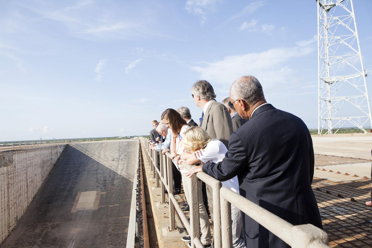 CAPE CANAVERAL, Fla. -- At the Kennedy Space Center in Florida, NASA administrator Charles Bolden, at right, enjoys an unobstructed view of the flame trench on Launch Pad 39B with Apollo astronauts and their families and friends. The pad is being modified to support the agency's new Orion spacecraft which will lift off atop the Space Launch System rocket. Orion is designed to take humans farther than they’ve ever gone before, serving as the exploration vehicle that will carry astronauts to deep space and sustain the crew during travel to destinations such as an asteroid or Mars. The visit of the former astronauts was part of NASA's 45th anniversary celebration of the Apollo 11 moon landing. As the world watched, the Apollo 11 astronauts landed in the moon's Sea of Tranquility aboard the lunar module Eagle on July 20, 1969. For more, visit http://www.nasa.gov/press/2014/july/nasa-honors-historic-first-moon-landing-eyes-first-mars-mission. Photo credit: NASA/Kim Shiflett