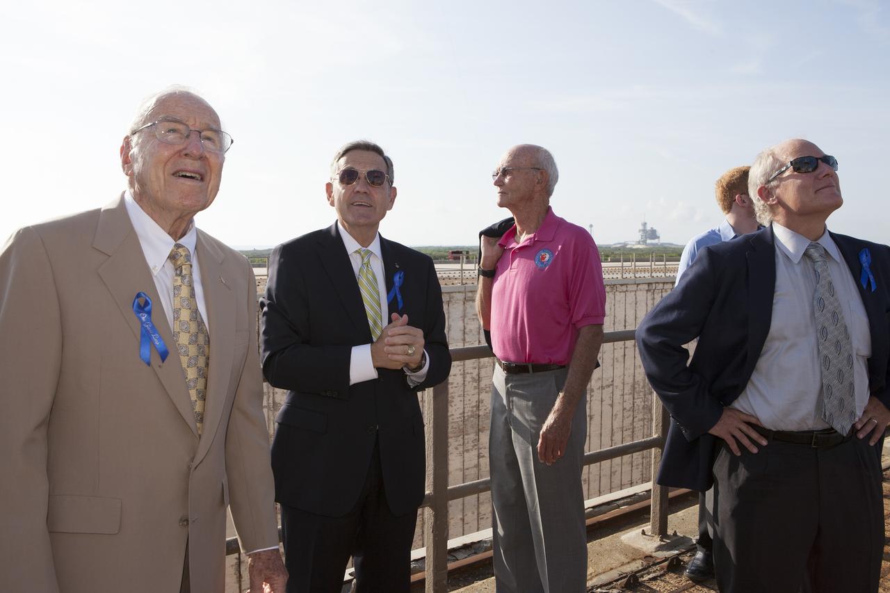 CAPE CANAVERAL, Fla. -- At the Kennedy Space Center in Florida, NASA officials and Apollo astronauts visiting Launch Pad 39B with their families and friends take a moment to enjoy the view. From left are Apollo astronaut Jim Lovell, Center Director Bob Cabana, Apollo 11 command module pilot Mike Collins, and Apollo 11 moonwalker Buzz Aldrin's son Andy Aldrin. The group is at Kennedy for a ceremony renaming the Operations and Checkout Building for Apollo 11 astronaut Neil Armstrong, the first person to set foot on the moon. The pad is being modified to support the agency's new Orion spacecraft which will lift off atop the Space Launch System rocket. Orion is designed to take humans farther than they’ve ever gone before, serving as the exploration vehicle that will carry astronauts to deep space and sustain the crew during travel to destinations such as an asteroid or Mars.      The visit of the former astronauts was part of NASA's 45th anniversary celebration of the Apollo 11 moon landing. As the world watched, Neil Armstrong and Neil Aldrin landed in the moon's Sea of Tranquility aboard the lunar module Eagle on July 20, 1969. Meanwhile, crewmate Michael Collins orbited above in the command module Columbia. For more, visit http://www.nasa.gov/press/2014/july/nasa-honors-historic-first-moon-landing-eyes-first-mars-mission. Photo credit: NASA/Kim Shiflett