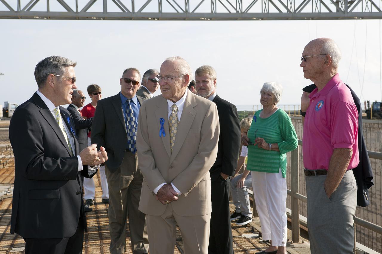 CAPE CANAVERAL, Fla. -- At the Kennedy Space Center in Florida, Center Director Robert Cabana, left, briefs Apollo astronauts Jim Lovell, center, and Mike Collins, right, on the changes underway to Launch Pad 39B. Behind them are the astronauts' families and friends. The pad is being modified to support the agency's new Orion spacecraft which will lift off atop the Space Launch System rocket. Orion is designed to take humans farther than they’ve ever gone before, serving as the exploration vehicle that will carry astronauts to deep space and sustain the crew during travel to destinations such as an asteroid or Mars. The visit of the former astronauts was part of NASA's 45th anniversary celebration of the Apollo 11 moon landing. As the world watched, the Apollo 11 astronauts landed in the moon's Sea of Tranquility aboard the lunar module Eagle on July 20, 1969. For more, visit http://www.nasa.gov/press/2014/july/nasa-honors-historic-first-moon-landing-eyes-first-mars-mission. Photo credit: NASA/Kim Shiflett