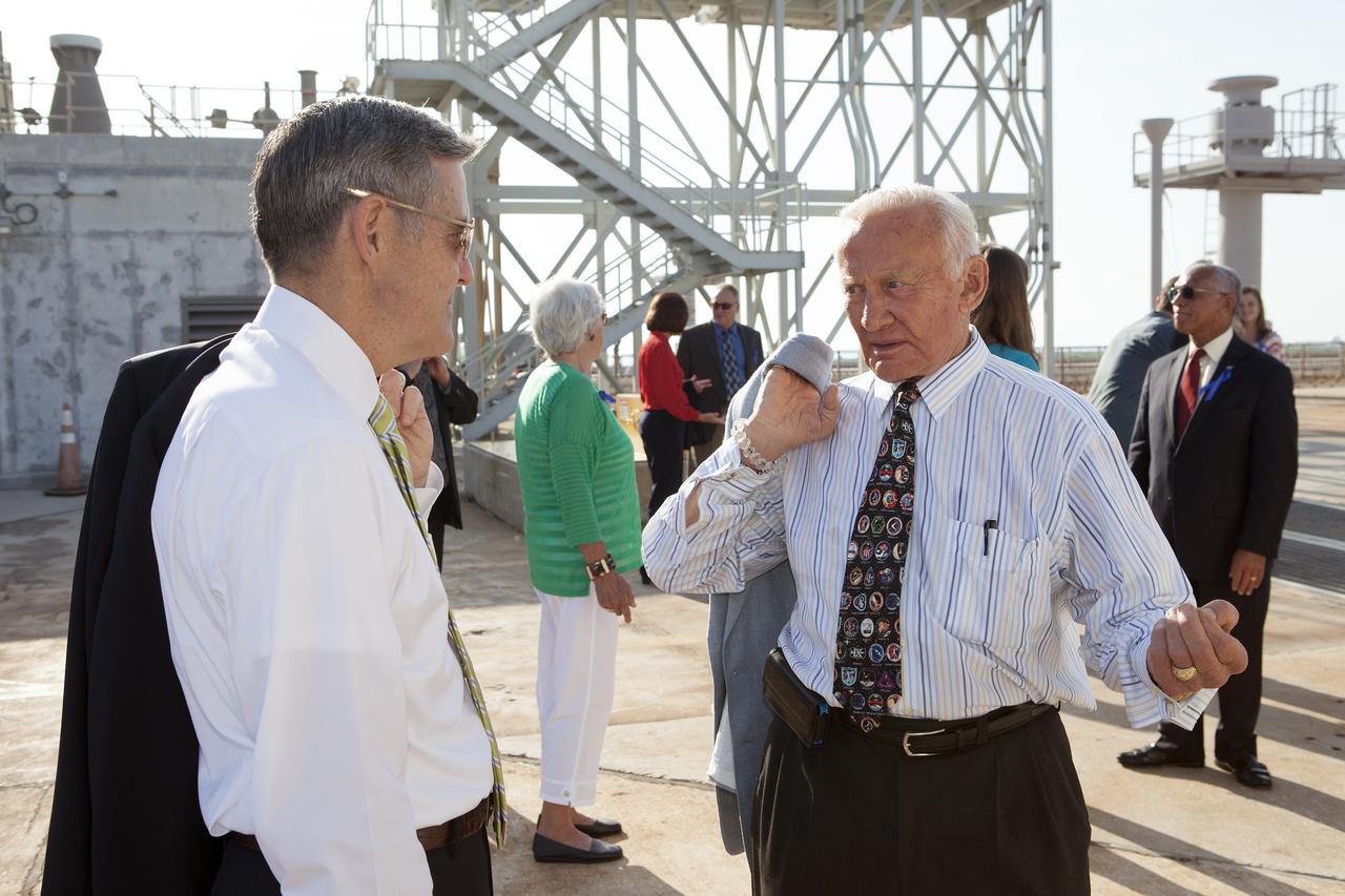 CAPE CANAVERAL, Fla. -- At the Kennedy Space Center in Florida, Center Director Robert Cabana, left, briefs Apollo 11 astronaut Buzz Aldren, right, on the changes underway to Launch Pad 39B. Behind them are the visiting Apollo astronauts' families and friends.The pad is being modified to support the agency's new Orion spacecraft which will lift off atop the Space Launch System rocket. Orion is designed to take humans farther than they’ve ever gone before, serving as the exploration vehicle that will carry astronauts to deep space and sustain the crew during travel to destinations such as an asteroid or Mars.      The visit was part of NASA's 45th anniversary celebration of the Apollo 11 moon landing. As the world watched, the Apollo 11 astronauts landed in the moon's Sea of Tranquility aboard the lunar module Eagle on July 20, 1969. For more, visit http://www.nasa.gov/press/2014/july/nasa-honors-historic-first-moon-landing-eyes-first-mars-mission. Photo credit: NASA/Kim Shiflett