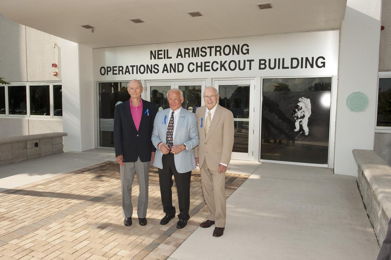 CAPE CANAVERAL, Fla. -- At the Kennedy Space Center in Florida, visiting Apollo astronauts have a group portrait taken in front of the refurbished Operations and Checkout Building, newly named for Apollo 11 astronaut Neil Armstrong, the first person to set foot on the moon. From left are Mike Collins, Buzz Aldrin and Jim Lovell. The building's high bay is being used to support the agency's new Orion spacecraft, which will lift off atop the Space Launch System rocket. Orion is designed to take humans farther than they’ve ever gone before, serving as the exploration vehicle that will carry astronauts to deep space and sustain the crew during travel to destinations such as an asteroid or Mars. The visit of the former astronauts was part of NASA's 45th anniversary celebration of the Apollo 11 moon landing. As the world watched, Neil Armstrong and Aldrin landed in the moon's Sea of Tranquility aboard the lunar module Eagle on July 20, 1969. Meanwhile, crewmate Collins orbited above in the command module Columbia. For more, visit http://www.nasa.gov/press/2014/july/nasa-honors-historic-first-moon-landing-eyes-first-mars-mission. Photo credit: NASA/Kevin O'Connell