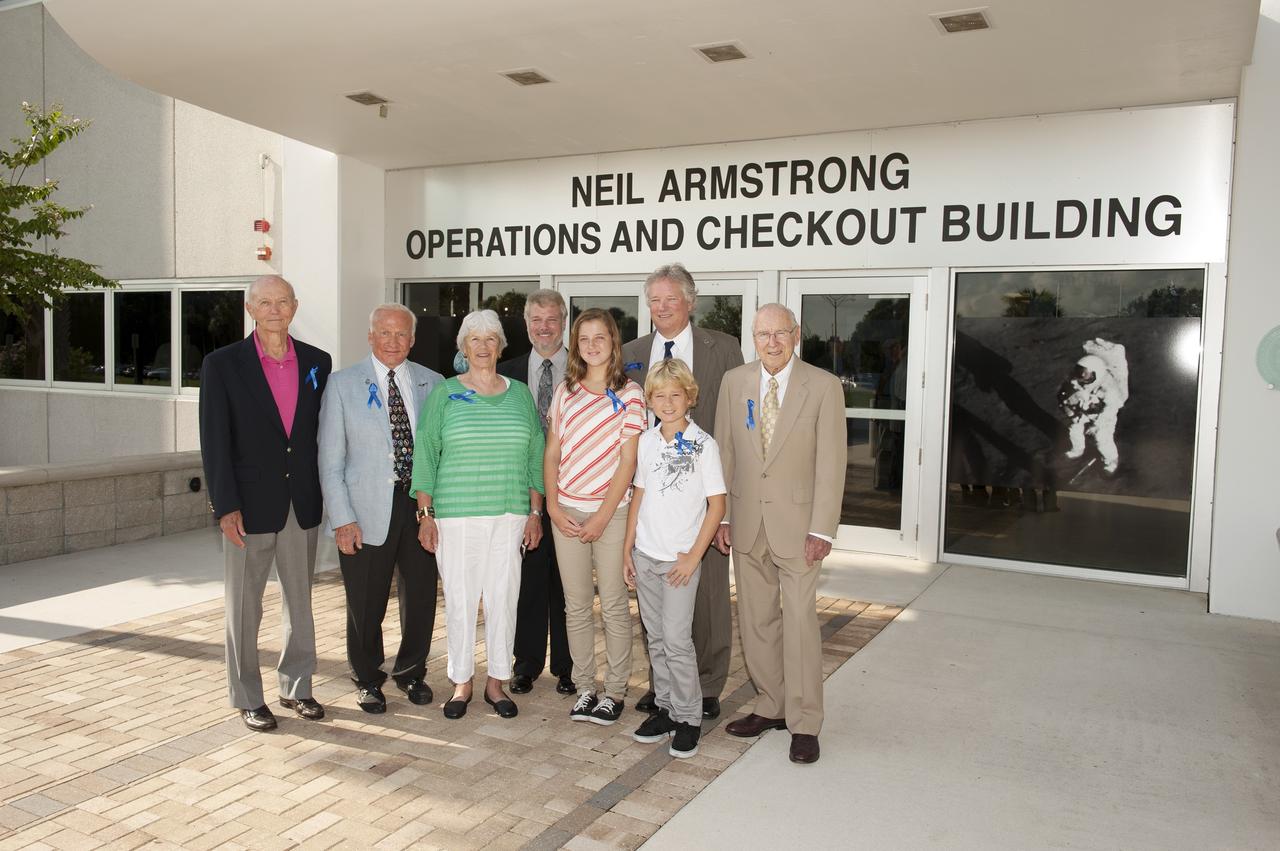 CAPE CANAVERAL, Fla. -- At the Kennedy Space Center in Florida, visiting Apollo astronauts have a group portrait taken in front of the refurbished Operations and Checkout Building, with the family of Neil Armstrong, the Apollo 11 astronaut who was the first person to set foot on the moon and for whom the facility is newly named. From left are Apollo 11 astronauts Mike Collins and Buzz Aldrin, Armstrong's former wife Janet, his son Rick, his granddaughter Lily, his son Rick, his grandson Bryce, and Apollo 8 and 13 astronaut Jim Lovell. The building's high bay is being used to support the agency's new Orion spacecraft, which will lift off atop the Space Launch System rocket. Orion is designed to take humans farther than they’ve ever gone before, serving as the exploration vehicle that will carry astronauts to deep space and sustain the crew during travel to destinations such as an asteroid or Mars.    The visit of the former astronauts was part of NASA's 45th anniversary celebration of the Apollo 11 moon landing. As the world watched, Neil Armstrong and Aldrin landed in the moon's Sea of Tranquility aboard the lunar module Eagle on July 20, 1969. Meanwhile, crewmate Collins orbited above in the command module Columbia. For more, visit http://www.nasa.gov/press/2014/july/nasa-honors-historic-first-moon-landing-eyes-first-mars-mission. Photo credit: NASA/Kevin O'Connell