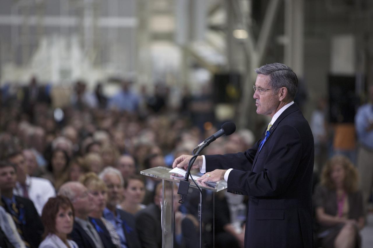 CAPE CANAVERAL, Fla. -- At the Kennedy Space Center in Florida, Center Director Robert Cabana addresses the audience at a ceremony renaming the refurbished Operations and Checkout Building for Apollo 11 astronaut Neil Armstrong, the first person to set foot on the moon. The building's high bay is being used to support the agency's new Orion spacecraft and is the same spaceport facility where the Apollo 11 command/service module and lunar module were prepped for the first lunar landing mission in 1969. Orion is designed to take humans farther than they’ve ever gone before, serving as the exploration vehicle that will carry astronauts to deep space and sustain the crew during travel to destinations such as an asteroid or Mars. The ceremony was part of NASA's 45th anniversary celebration of the Apollo 11 moon landing. As the world watched, Neil Armstrong and Buzz Aldrin landed in the moon's Sea of Tranquility on July 20, 1969, aboard the lunar module Eagle. Meanwhile, crewmate Michael Collins orbited above in the command module Columbia. For more, visit http://www.nasa.gov/press/2014/july/nasa-honors-historic-first-moon-landing-eyes-first-mars-mission. Photo credit: NASA/Kim Shiflett