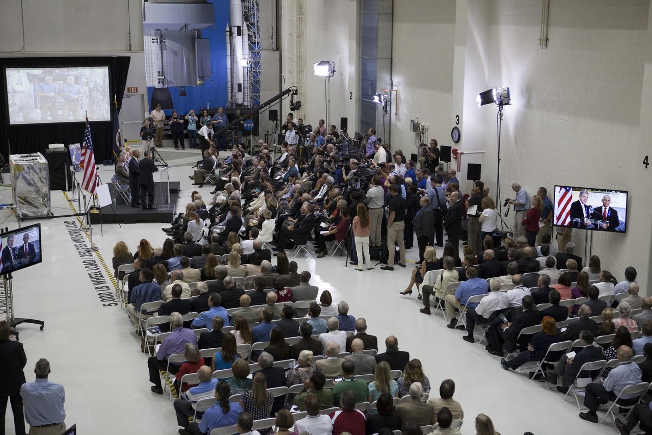 CAPE CANAVERAL, Fla. -- At the Kennedy Space Center in Florida, a crowd turns out for a ceremony renaming the refurbished Operations and Checkout Building for Apollo 11 astronaut Neil Armstrong, the first person to set foot on the moon. The building's high bay is being used to support the agency's new Orion spacecraft and is the same spaceport facility where the Apollo 11 command/service module and lunar module were prepped for the first lunar landing mission in 1969. Orion is designed to take humans farther than they’ve ever gone before, serving as the exploration vehicle that will carry astronauts to deep space and sustain the crew during travel to destinations such as an asteroid or Mars. The ceremony was part of NASA's 45th anniversary celebration of the Apollo 11 moon landing. As the world watched, Neil Armstrong and Buzz Aldrin landed in the moon's Sea of Tranquility on July 20, 1969, aboard the lunar module Eagle. Meanwhile, crewmate Michael Collins orbited above in the command module Columbia. For more, visit http://www.nasa.gov/press/2014/july/nasa-honors-historic-first-moon-landing-eyes-first-mars-mission. Photo credit: NASA/Kim Shiflett