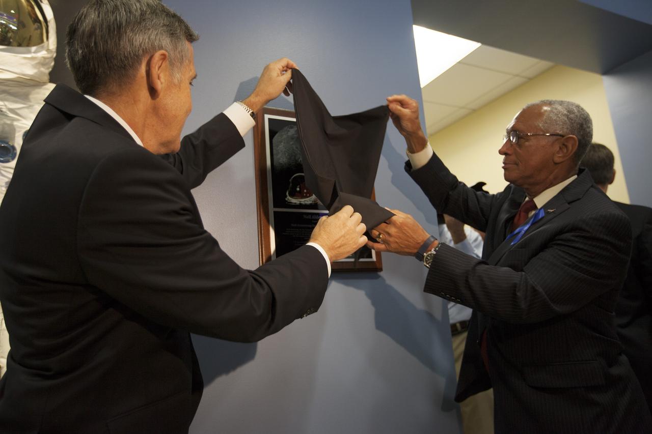CAPE CANAVERAL, Fla. -- At the Kennedy Space Center in Florida, Center Director Robert Cabana, left, and NASA Administrator Charles Bolden unveil a plaque on display in the lobby of the newly named Neil Armstrong Operations and Checkout Building. The facility has been renamed for Apollo 11 astronaut Neil Armstrong, the first person to set foot on the moon. The building's high bay is being used to support the agency's new Orion spacecraft and is the same spaceport facility where the Apollo 11 command/service module and lunar module were prepped for the first lunar landing mission in 1969. Orion is designed to take humans farther than they’ve ever gone before, serving as the exploration vehicle that will carry astronauts to deep space and sustain the crew during travel to destinations such as an asteroid or Mars. The unveiling was part of NASA's 45th anniversary celebration of the Apollo 11 moon landing. As the world watched, Apollo 11 astronauts landed in the moon's Sea of Tranquility aboard the lunar module, Eagle, on July 20, 1969, as the command module, Columbia, orbited overhead. For more: http://www.nasa.gov/press/2014/july/nasa-honors-historic-first-moon-landing-eyes-first-mars-mission/ Photo credit: NASA/Kim Shiflett