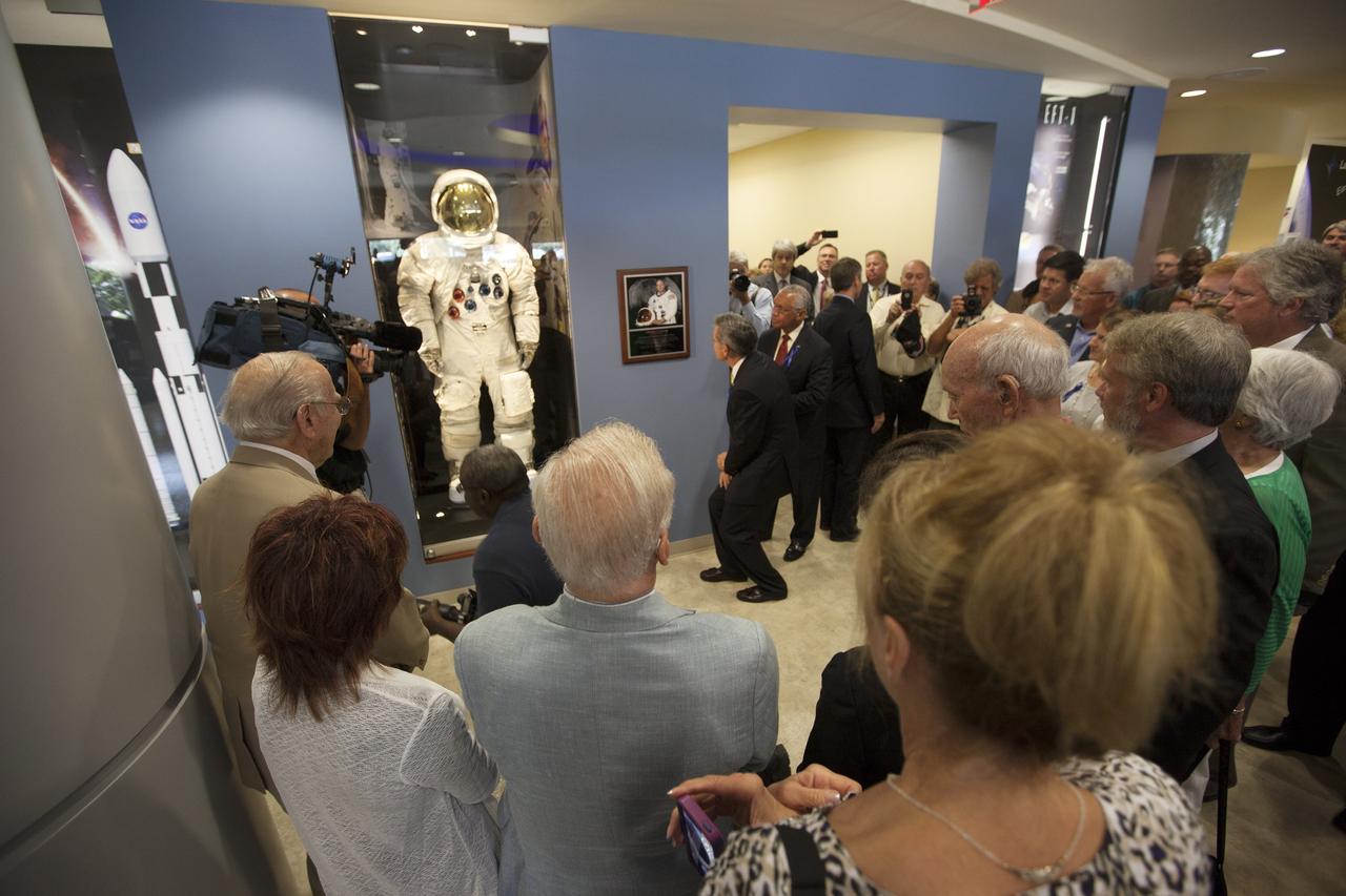 CAPE CANAVERAL, Fla. -- At the Kennedy Space Center in Florida, Center Director Robert Cabana reads the inscription on a plaque to invited guests following its unveiling in the lobby of the newly named Neil Armstrong Operations and Checkout Building. NASA Administrator Charles Bolden is at his right. The facility has been renamed for Apollo 11 astronaut Neil Armstrong, the first person to set foot on the moon. The building's high bay is being used to support the agency's new Orion spacecraft and is the same spaceport facility where the Apollo 11 command/service module and lunar module were prepped for the first lunar landing mission in 1969. Orion is designed to take humans farther than they’ve ever gone before, serving as the exploration vehicle that will carry astronauts to deep space and sustain the crew during travel to destinations such as an asteroid or Mars. The unveiling was part of NASA's 45th anniversary celebration of the Apollo 11 moon landing. As the world watched, Apollo 11 astronauts landed in the moon's Sea of Tranquility aboard the lunar module, Eagle, on July 20, 1969, as the command module, Columbia, orbited overhead. For more: http://www.nasa.gov/press/2014/july/nasa-honors-historic-first-moon-landing-eyes-first-mars-mission/ Photo credit: NASA/Kim Shiflett