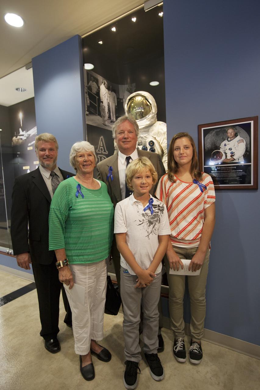 CAPE CANAVERAL, Fla. -- At the Kennedy Space Center in Florida, members of the Armstrong family pose beside a plaque following its unveiling in the lobby of the newly named Neil Armstrong Operations and Checkout Building. The facility has been renamed for Apollo 11 astronaut Neil Armstrong, the first person to set foot on the moon. From left are Armstrong's son Mark, his former wife Janet, his son Rick, his grandson Bryce, and his granddaughter Lily. The building's high bay is being used to support the agency's new Orion spacecraft and is the same spaceport facility where the Apollo 11 command/service module and lunar module were prepped for the first lunar landing mission in 1969. Orion is designed to take humans farther than they’ve ever gone before, serving as the exploration vehicle that will carry astronauts to deep space and sustain the crew during travel to destinations such as an asteroid or Mars.    The unveiling was part of NASA's 45th anniversary celebration of the Apollo 11 moon landing. As the world watched, Apollo 11 astronauts landed in the moon's Sea of Tranquility aboard the lunar module, Eagle, on July 20, 1969, as the command module, Columbia, orbited overhead. For more: http://www.nasa.gov/press/2014/july/nasa-honors-historic-first-moon-landing-eyes-first-mars-mission/ Photo credit: NASA/Kim Shiflett