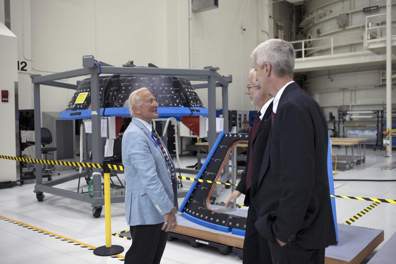 CAPE CANAVERAL, Fla. -- At the Kennedy Space Center in Florida, NASA officials and Apollo astronauts tour the refurbished Operations and Checkout Building, newly named for Apollo 11 astronaut Neil Armstrong, the first person to set foot on the moon. From left, are Apollo 11 astronaut Buzz Aldrin, Mark Geyer, Orion Program manager, and Scott Wilson, manager, production operations for the Orion Program. Also at the renaming ceremony were Apollo astronauts Michael Collins and Jim Lovell. The building's high bay is being used to support the agency's new Orion spacecraft, which will lift off atop the Space Launch System. Orion is designed to take humans farther than they've ever gone before, serving as the exploration vehicle that will carry astronauts to deep space and sustain the crew during travel to destinations such as an asteroid or Mars. The visit of the former astronauts was part of NASA's 45th anniversary celebration of the moon landing. As the world watched, Neil Armstrong and Aldrin landed in the moon's Sea of Tranquility aboard the lunar module Eagle on July 20, 1969. Meanwhile, crewmate Collins orbited above in the command module Columbia. For more, visit http://www.nasa.gov/press/2014/july/nasa-honors-historic-first-moon-landing-eyes-first-mars-mission. Photo credit: NASA/Kim Shiflett