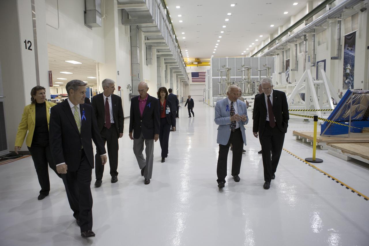 CAPE CANAVERAL, Fla. -- At the Kennedy Space Center in Florida, NASA officials and Apollo astronauts tour the refurbished Operations and Checkout Building, newly named for Apollo 11 astronaut Neil Armstrong, the first person to set foot on the moon. Leading the way at left is Kennedy Center Director Bob Cabana, Scott Wilson, manager, production operations for the Orion Program, and Apollo 11 astronaut Michael Collins. At right is Apollo 11 astronaut Buzz Aldrin, and Mark Geyer, Orion Program manager. The building's high bay is being used to support the agency's new Orion spacecraft, which will lift off atop the Space Launch System. Orion is designed to take humans farther than they've ever gone before, serving as the exploration vehicle that will carry astronauts to deep space and sustain the crew during travel to destinations such as an asteroid or Mars. The visit of the former astronauts was part of NASA's 45th anniversary celebration of the moon landing. As the world watched, Neil Armstrong and Aldrin landed in the moon's Sea of Tranquility aboard the lunar module Eagle on July 20, 1969. Meanwhile, crewmate Collins orbited above in the command module Columbia. For more, visit http://www.nasa.gov/press/2014/july/nasa-honors-historic-first-moon-landing-eyes-first-mars-mission. Photo credit: NASA/Kim Shiflett