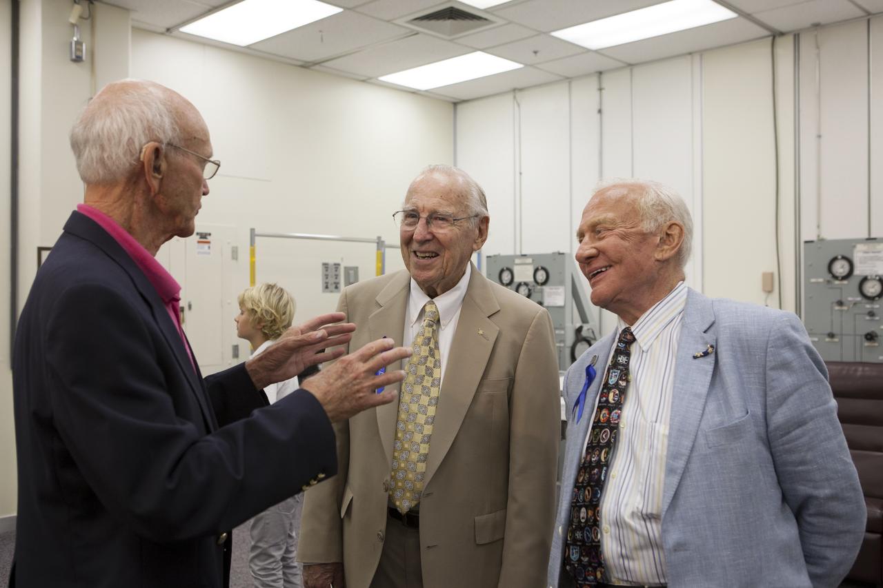 CAPE CANAVERAL, Fla. -- Apollo astronauts and their families tour the astronaut crew quarters in the Operations and Checkout Building at NASA's Kennedy Space Center in Florida. Here, from left, Apollo 11 command module pilot Michael Collins, Apollo 8 and Apollo 13 crew member Jim Lovell, and Apollo 11 moonwalker Buzz Aldrin share a light moment. The tour followed a ceremony renaming the refurbished Operations and Checkout Building for Apollo 11 astronaut Neil Armstrong, the first person to set foot on the moon. Besides housing the crew quarters, the building's high bay is being used to support the agency's new Orion spacecraft and is the same spaceport facility where the Apollo 11 command/service module and lunar module were prepped for the first lunar landing mission in 1969. Orion is designed to take humans farther than they’ve ever gone before, serving as the exploration vehicle that will carry astronauts to deep space and sustain the crew during travel to destinations such as an asteroid or Mars. The visit of the former astronauts was part of NASA's 45th anniversary celebration of the moon landing. As the world watched, Neil Armstrong and Aldrin landed in the moon's Sea of Tranquility aboard the lunar module Eagle on July 20, 1969. Meanwhile, crewmate Collins orbited above in the command module Columbia. For more, visit http://www.nasa.gov/press/2014/july/nasa-honors-historic-first-moon-landing-eyes-first-mars-mission. Photo credit: NASA/Kim Shiflett