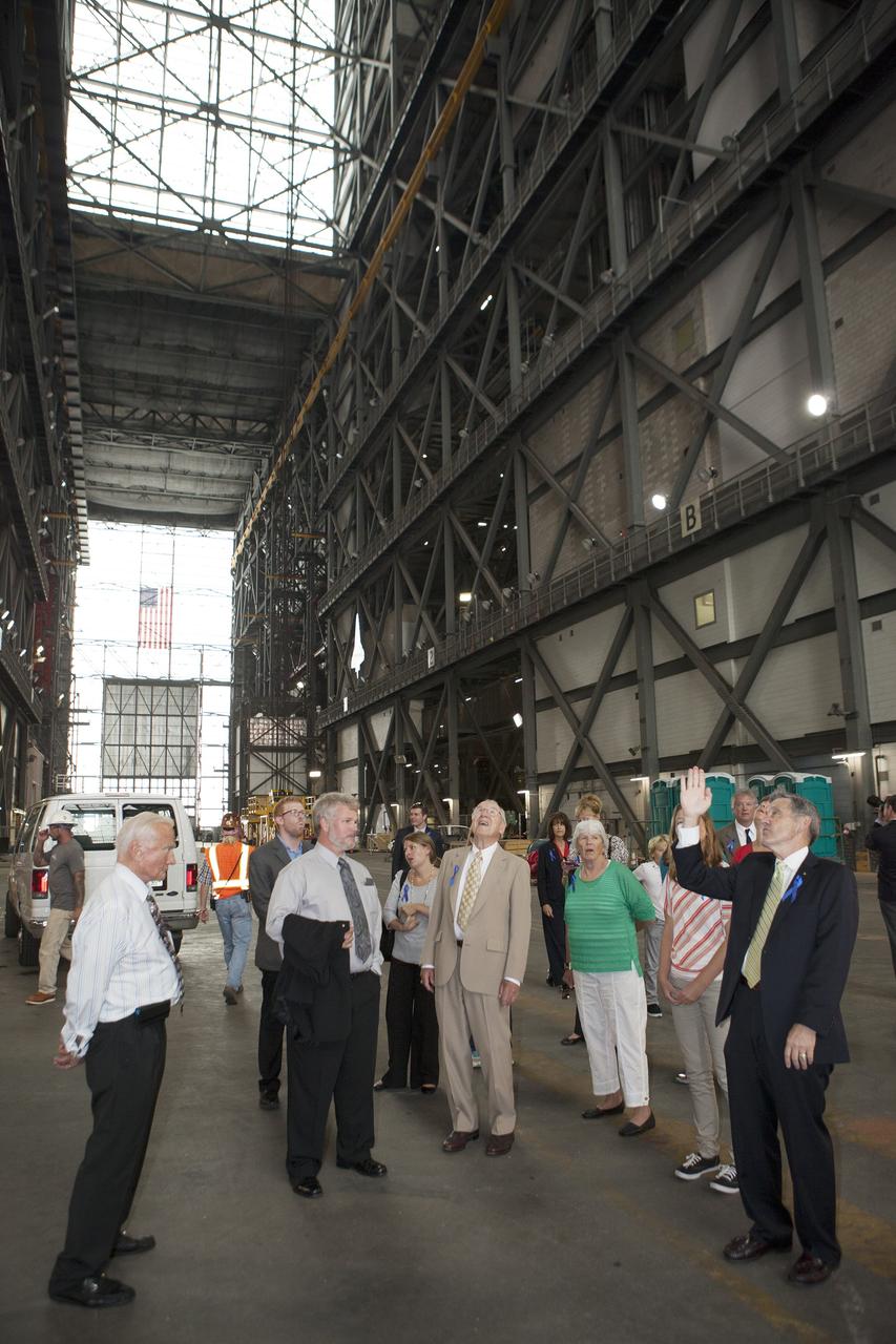 CAPE CANAVERAL, Fla. -- Kennedy Space Center Director Robert Cabana, at right, escorts Apollo astronauts and their families through the transfer aisle of the 525-foot-tall Vehicle Assembly Building, the facility in which Apollo's Saturn V rockets were processed at NASA's Kennedy Space Center in Florida. The visit followed a ceremony renaming Kennedy's refurbished Operations and Checkout Building for Apollo 11 astronaut Neil Armstrong, the first person to set foot on the moon. In front of the group, from left, are Apollo 11 moonwalker Buzz Aldrin, Armstrong's son Mark, Apollo astronaut Jim Lovell, Armstrong's former wife Janet, and Cabana.    The ceremony was part of NASA's 45th anniversary celebration of the Apollo 11 moon landing. As the world watched, Neil Armstrong and Buzz Aldrin landed in the moon's Sea of Tranquility on July 20, 1969, aboard the lunar module Eagle. Meanwhile, crewmate Michael Collins orbited above in the command module Columbia. For more, visit http://www.nasa.gov/press/2014/july/nasa-honors-historic-first-moon-landing-eyes-first-mars-mission.  Photo credit: NASA/Kim Shiflett