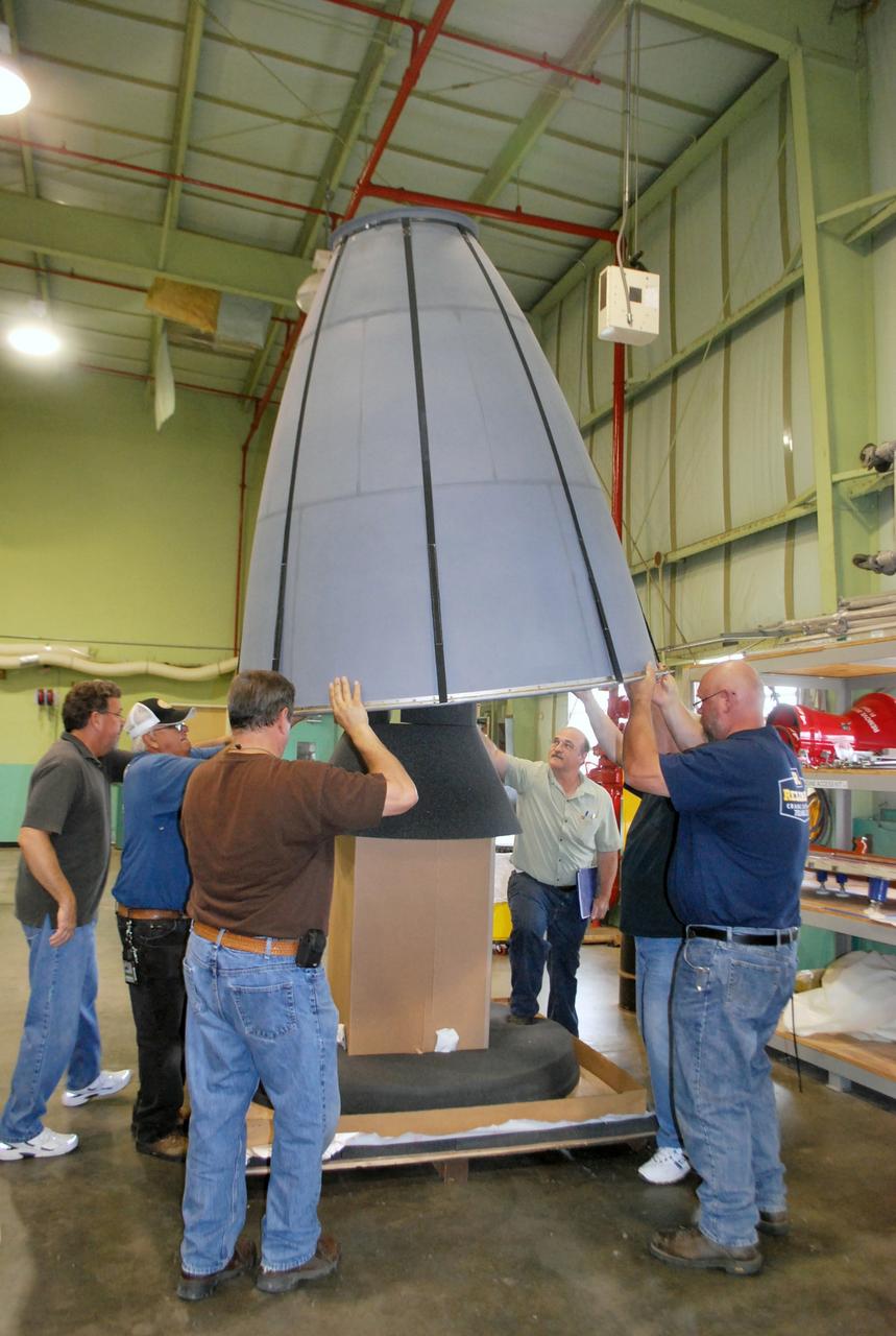 VANDENBERG AIR FORCE BASE, Calif. – It takes teamwork to lift the nozzle for the second stage of a United Launch Alliance Delta II rocket from its work stand in the Horizontal Processing Facility at Space Launch Complex 2 on Vandenberg Air Force Base in California.      The Delta II will be used to loft NASA's Soil Moisture Active Passive mission, or SMAP, into orbit. The spacecraft will provide global measurements of soil moisture and its freeze/thaw state. These measurements will be used to enhance understanding of processes that link the water, energy and carbon cycles, and to extend the capabilities of weather and climate prediction models. The data returned also will be used to quantify net carbon flux in boreal landscapes and to develop improved flood prediction and drought monitoring capabilities. Launch is scheduled for November 2014. To learn more about SMAP, visit http://smap.jpl.nasa.gov.  Photo credit: NASA/Randy Beaudoin